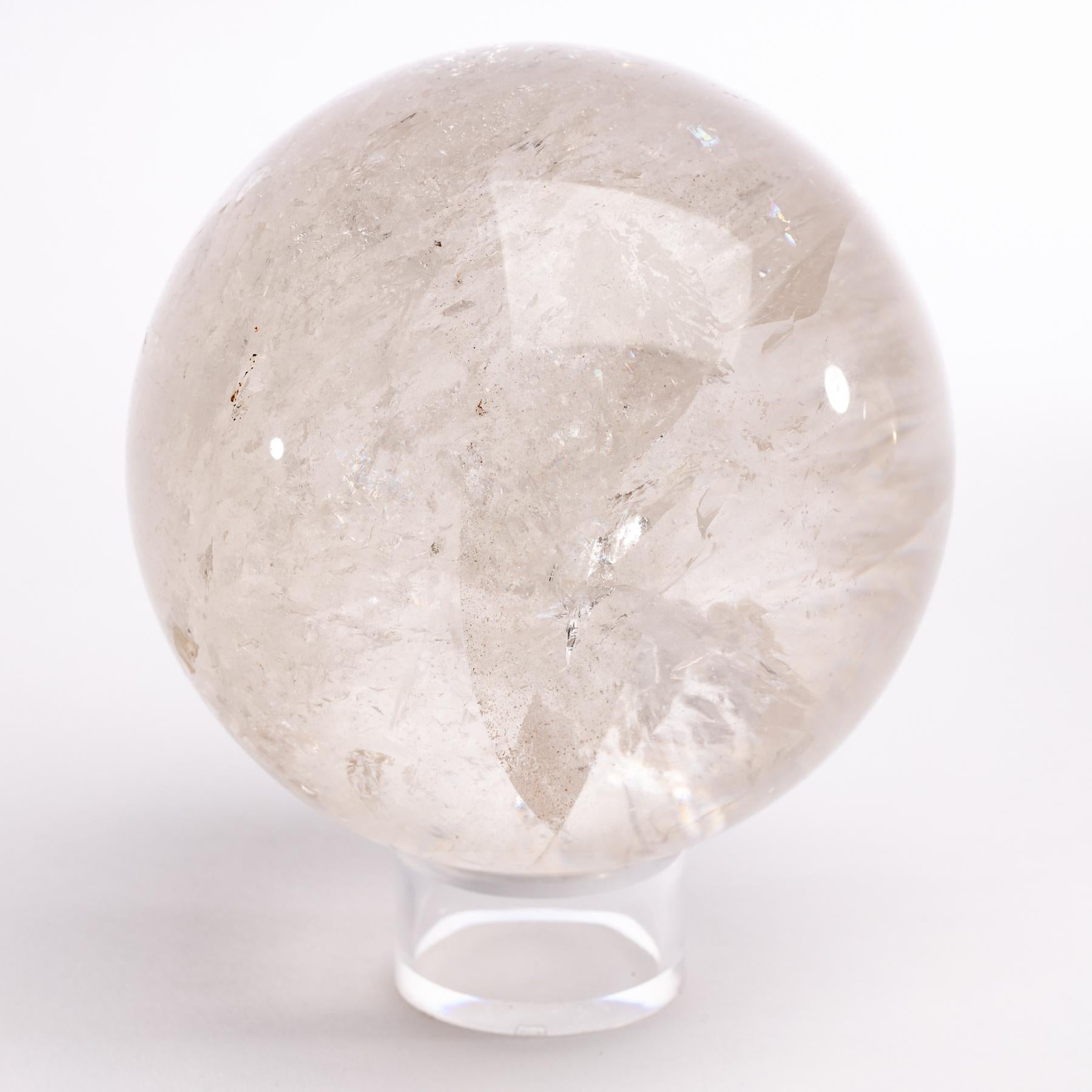 Large clear Brazilian quartz sphere mounted on a acrylic ring.
