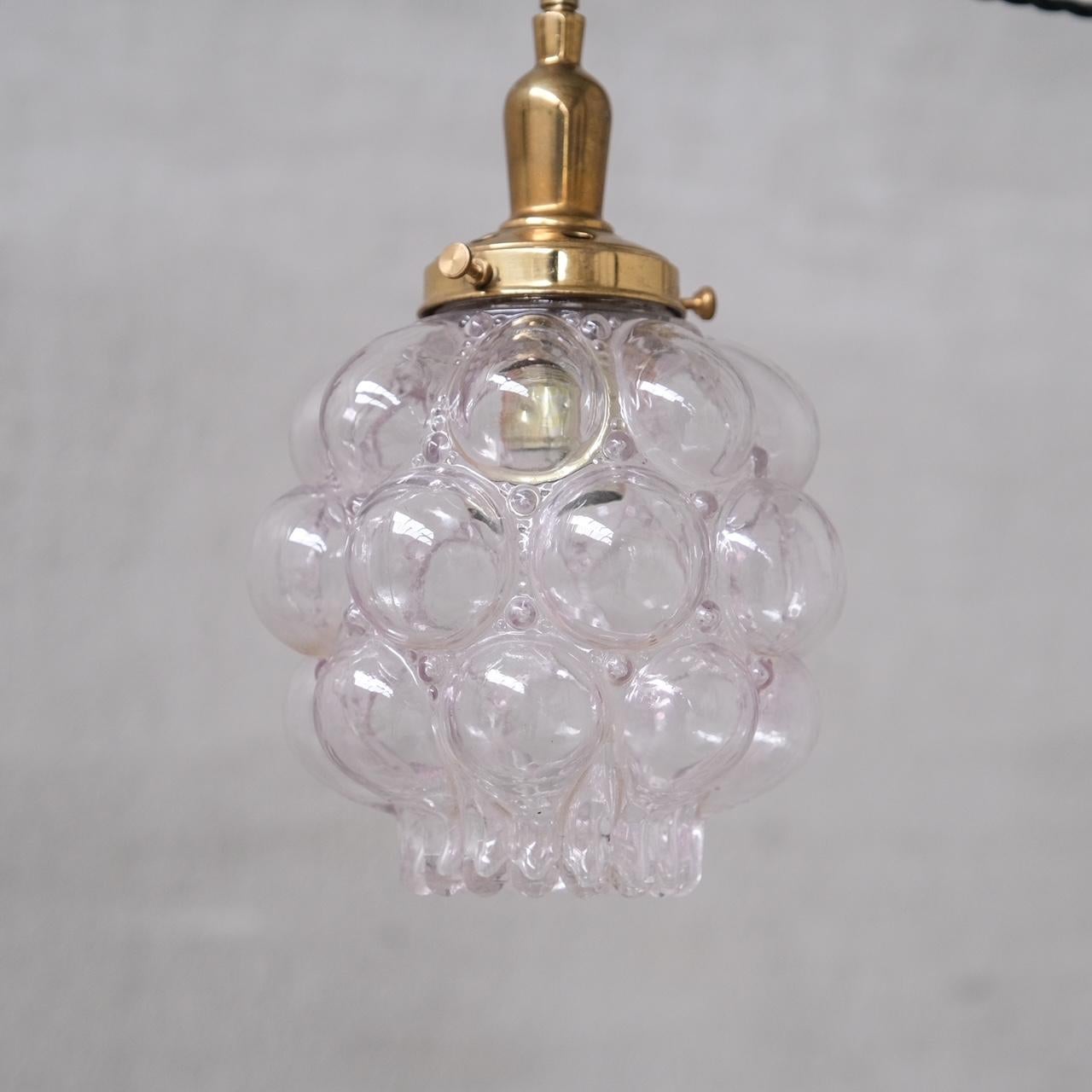 A small brass and glass pendant light.

France, c1960s.

Unusual bubble like form.

No chain or rose was retained, however they are easy to source online.

Good vintage condtion, re-wired and PAT tested.

Location: Belgium Gallery.

Dimensions: 27 H