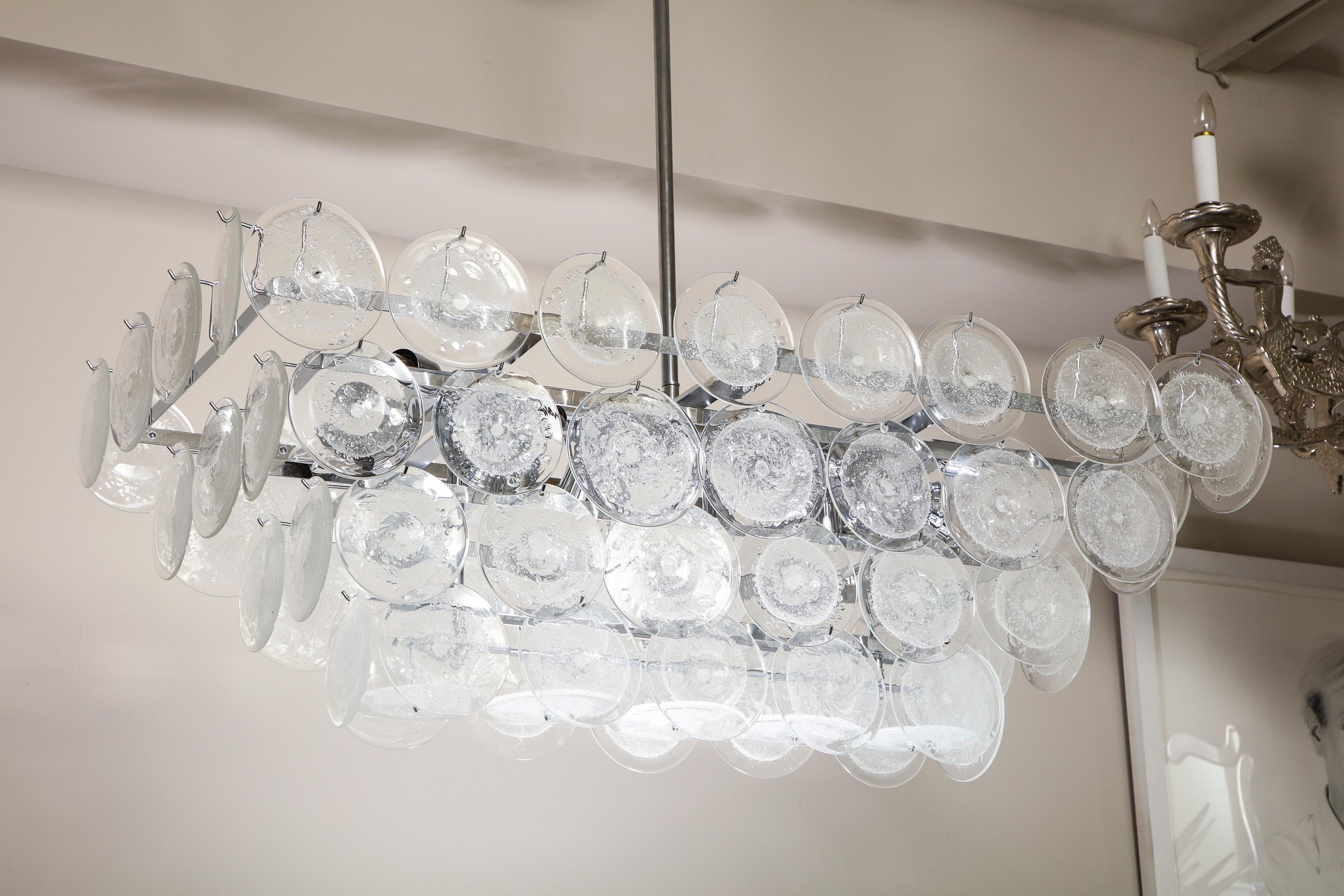 Custom clear bubble Murano glass disc chandelier in a rectangle shape and chrome finish. Each glass piece is handmade in Murano, Italy. 18 candelabra sockets to illuminate for the size listed. Customization is available for different sizes, finishes