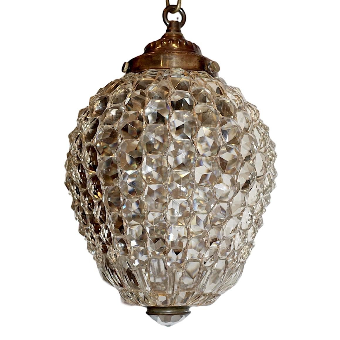 A circa 1920s French clear crystal pendant light fixture with interior light.

Measurements:
Current drop 16