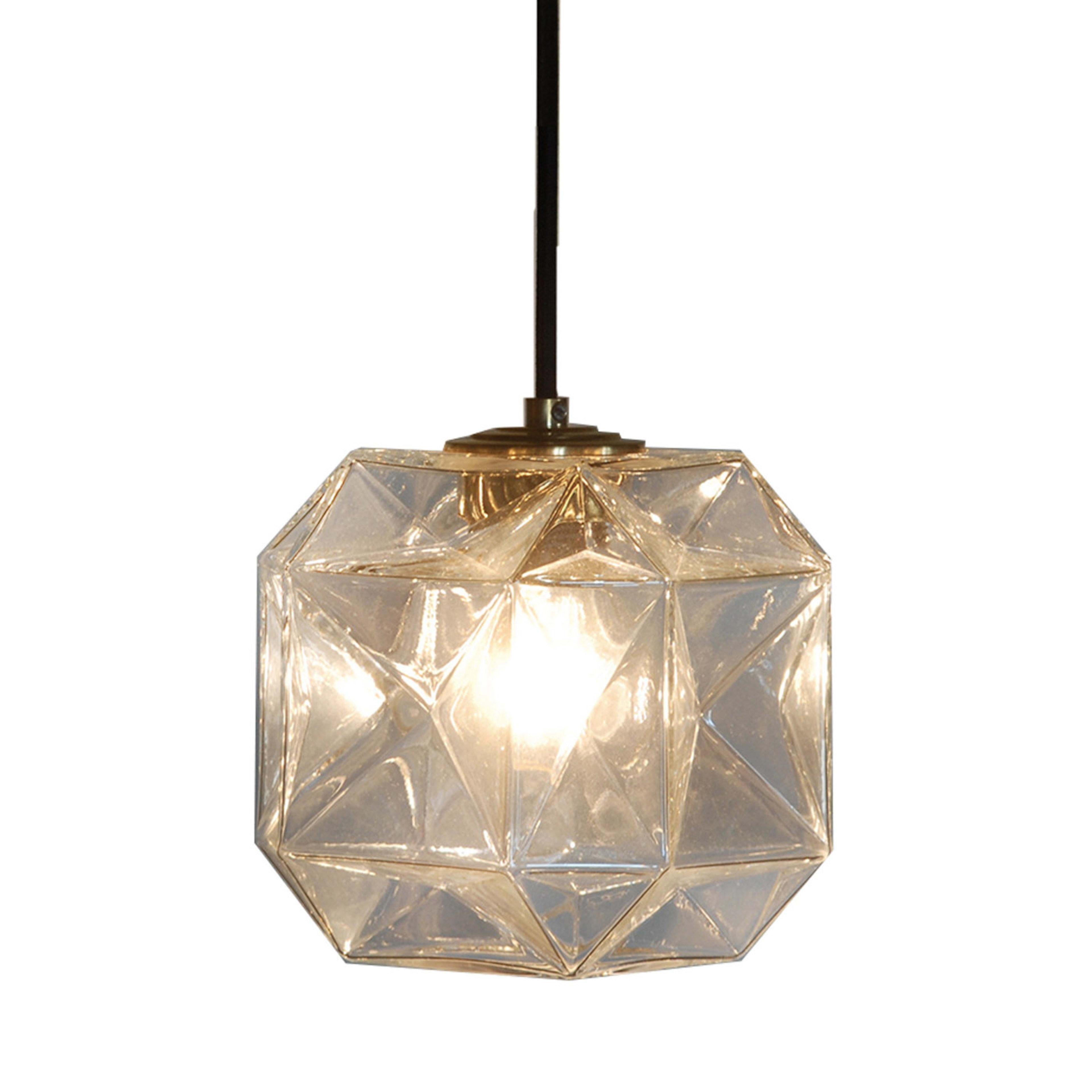 This suspended light features a unique and innovative shade constructed from mouth blown Venetian glass in the shape of a faceted cube. The different facets each catch the light producing interesting reflections and illuminating the space. This