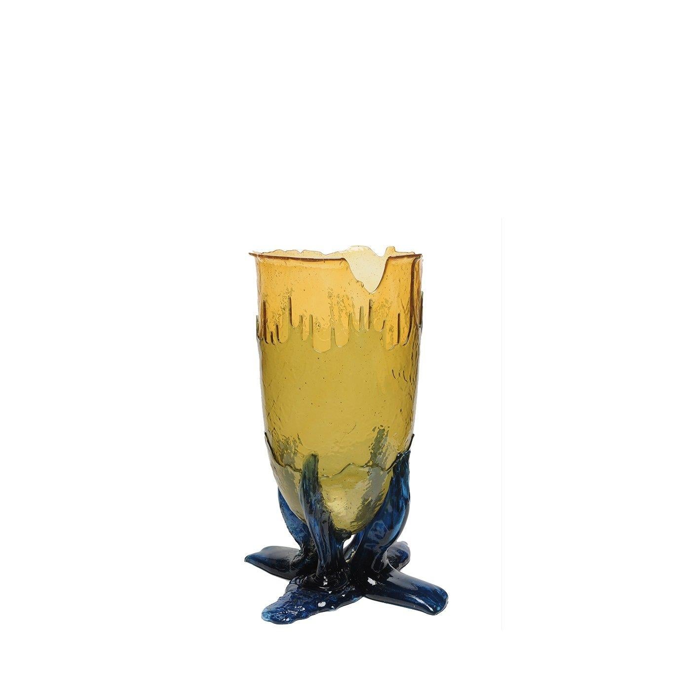 Designed by Gaetano Pesce in 1995 for Fish Design collection, this vase was crafted of soft resin and is comprised of a base made of four stylized legs in blue supporting an elongated conical body in yellow whose different layers seem to have been