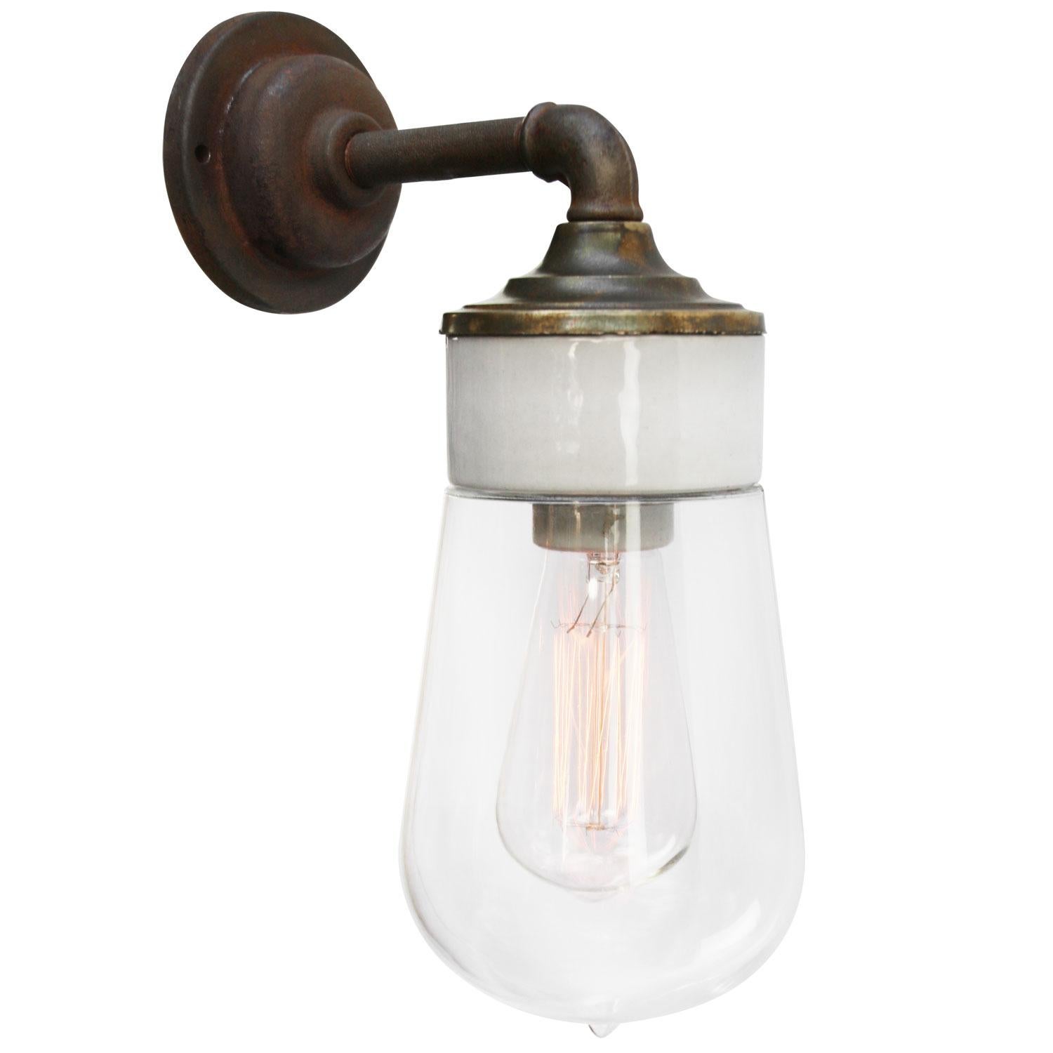 Porcelain Industrial wall lamp.
White porcelain, brass and cast iron
Clear glass.
2 conductors, no ground.

Diameter cast iron wall piece 10.5 cm / 4”.
2 holes to secure.

Weight: 1.95 kg / 4.3 lb

Priced per individual item. All lamps have been
