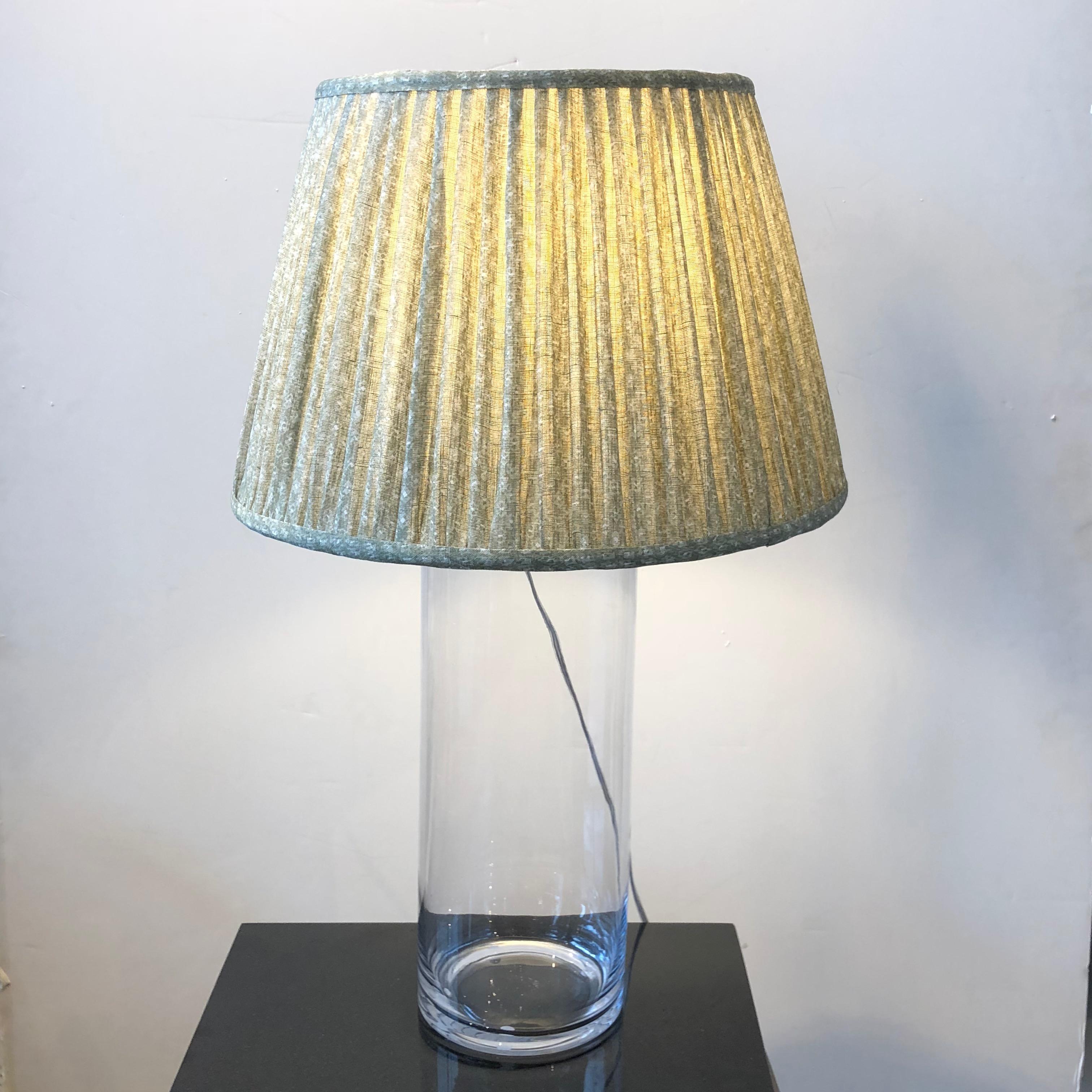 Clear glass cylinder lamp with brass hardware.
Custom shade sold separately.
