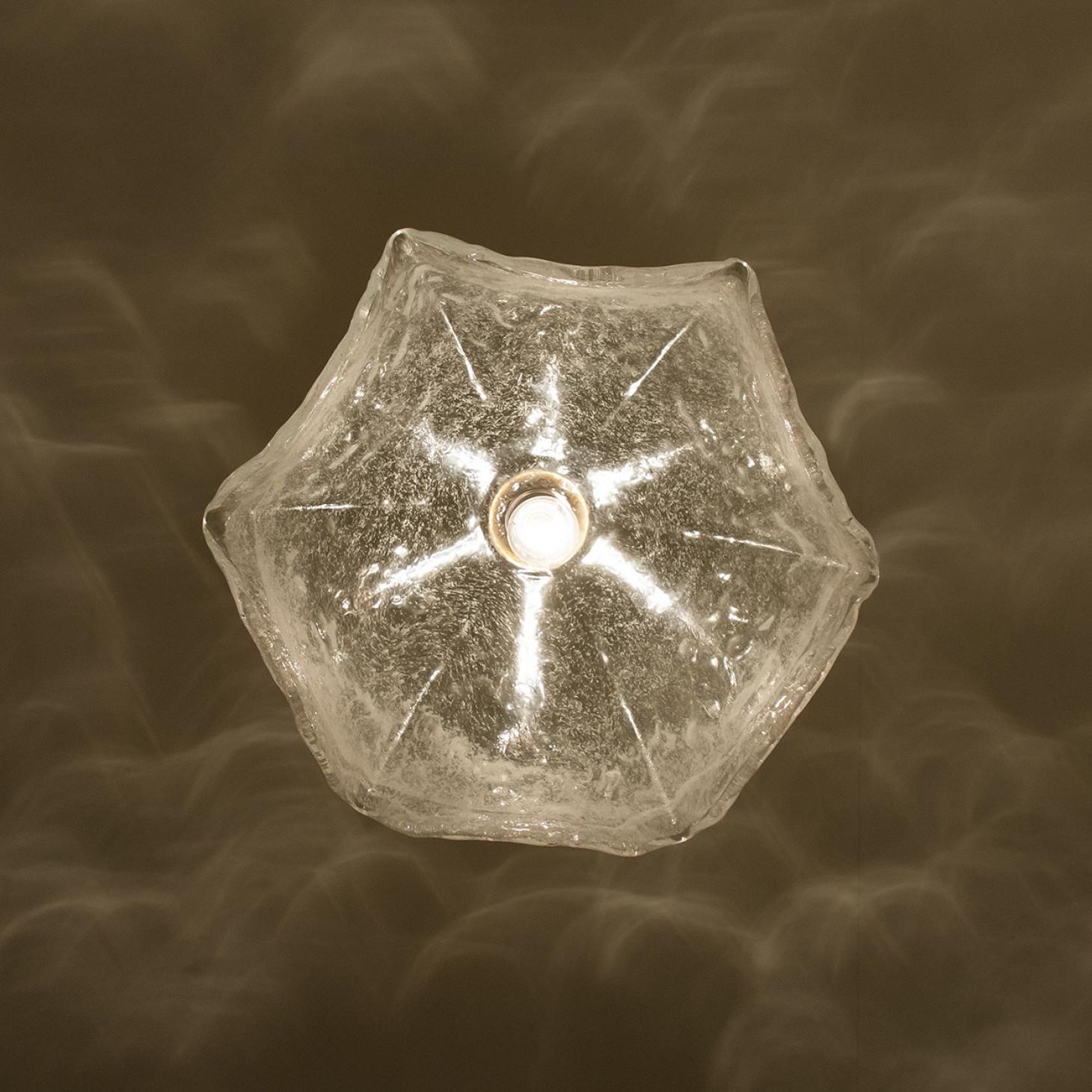 Esempio modernista di eleganza tradizionale. Struttura in ottone di qualità in un elegante colore oro caldo, composta da vetro soffiato trasparente che si raccoglie al centro dell'apparecchio formando un motivo floreale.

Il fiore in vetro soffiato