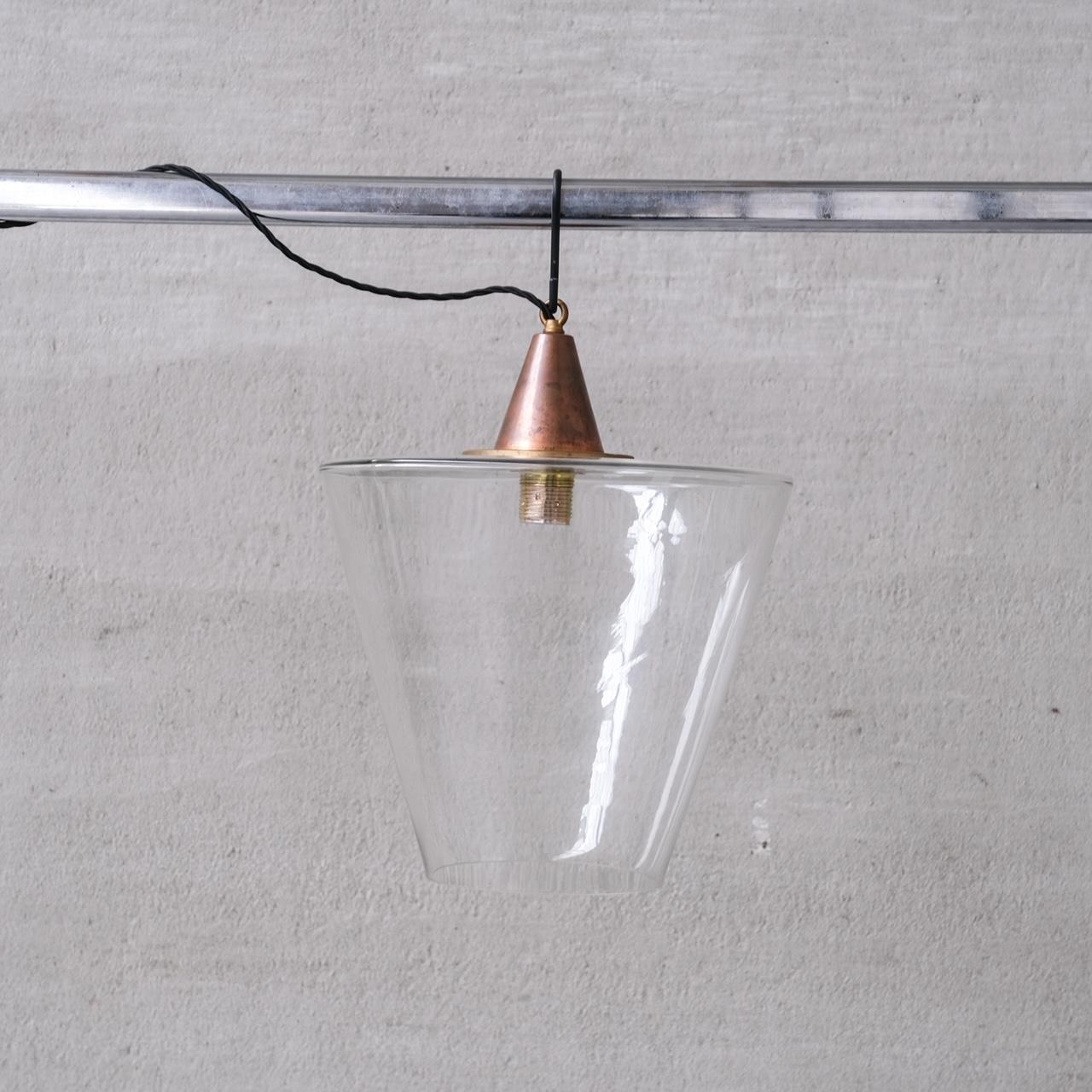 A larger sized clear glass pendant.

France, c1950s.

Copper gallery.

Conical base with open bottom.

Since re-wired and PAT tested.

Good vintage condition, some scuffs and wear commensurate with age.

Internal Ref: 18/10/23/009.

Location: