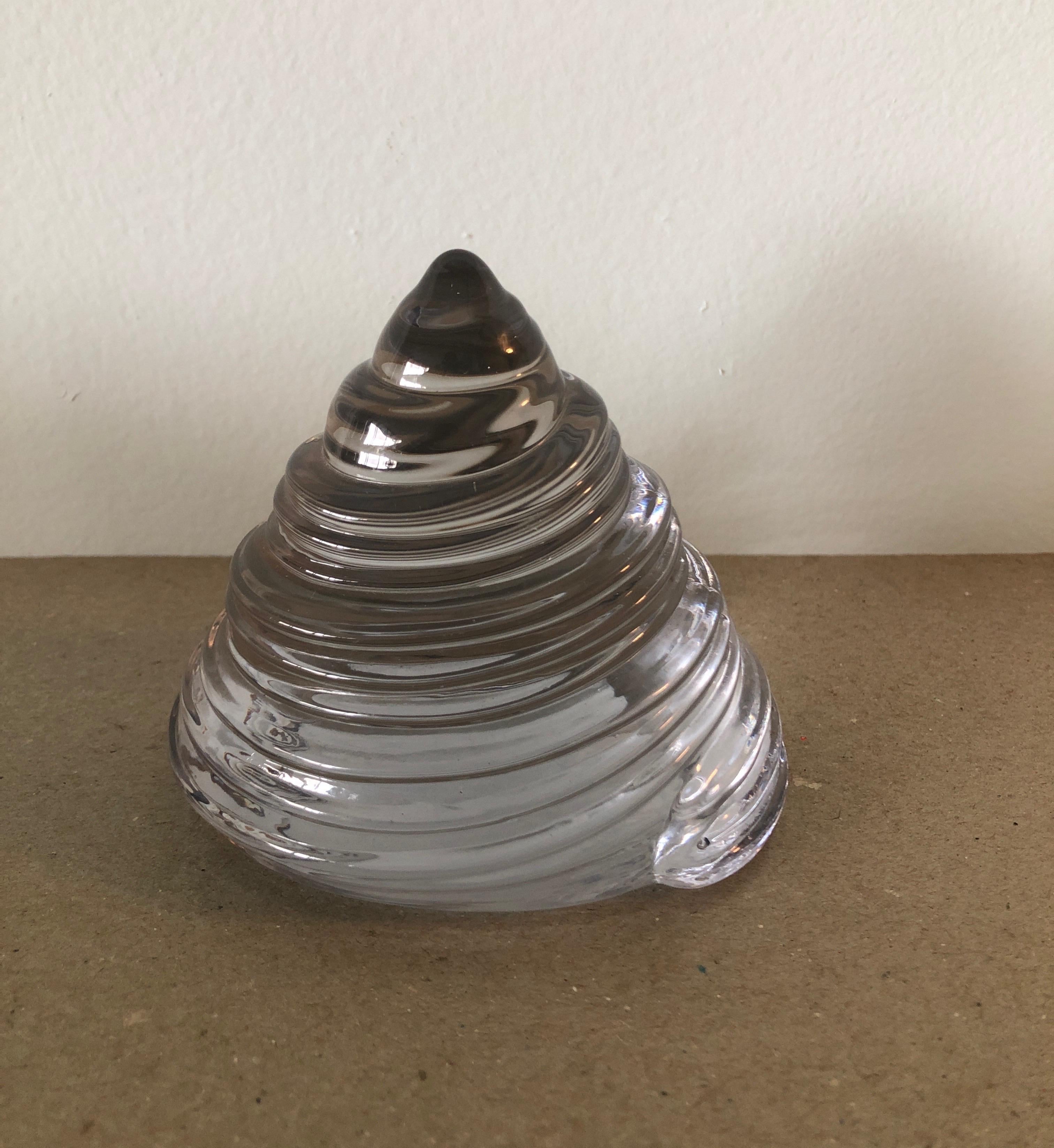 Clear glass paperweight in a cone shell shape.
Size: 4.5