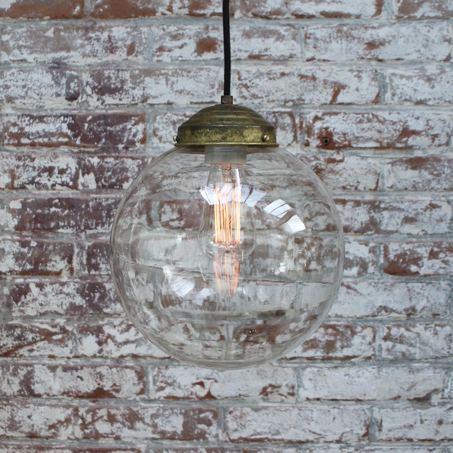 Large round clear glass pendant
2 meter black cotton wire
brass top

Weight: 1.20 kg / 2.6 lb

Priced per individual item. All lamps have been made suitable by international standards for incandescent light bulbs, energy-efficient and LED bulbs.