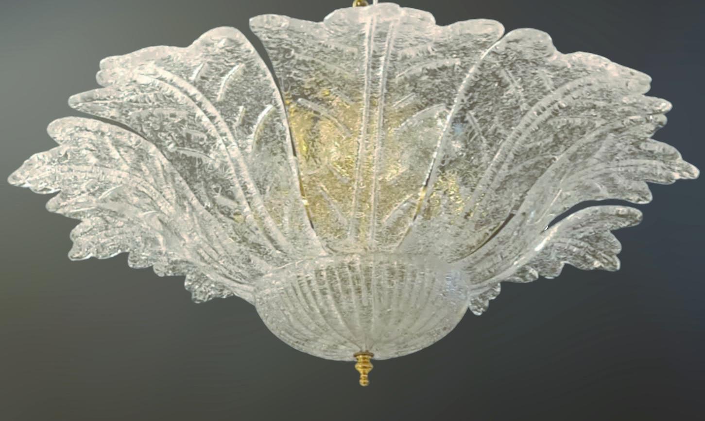 Vintage Italian Murano glass flush mount with clear graniglia glass leaves mounted on gold metal frame / Made in Italy in the style of Barovier e Toso, circa 1960s
6 lights / E12 or E14 type / max 40W each
Measures: Diameter 25.5 inches, height 10
