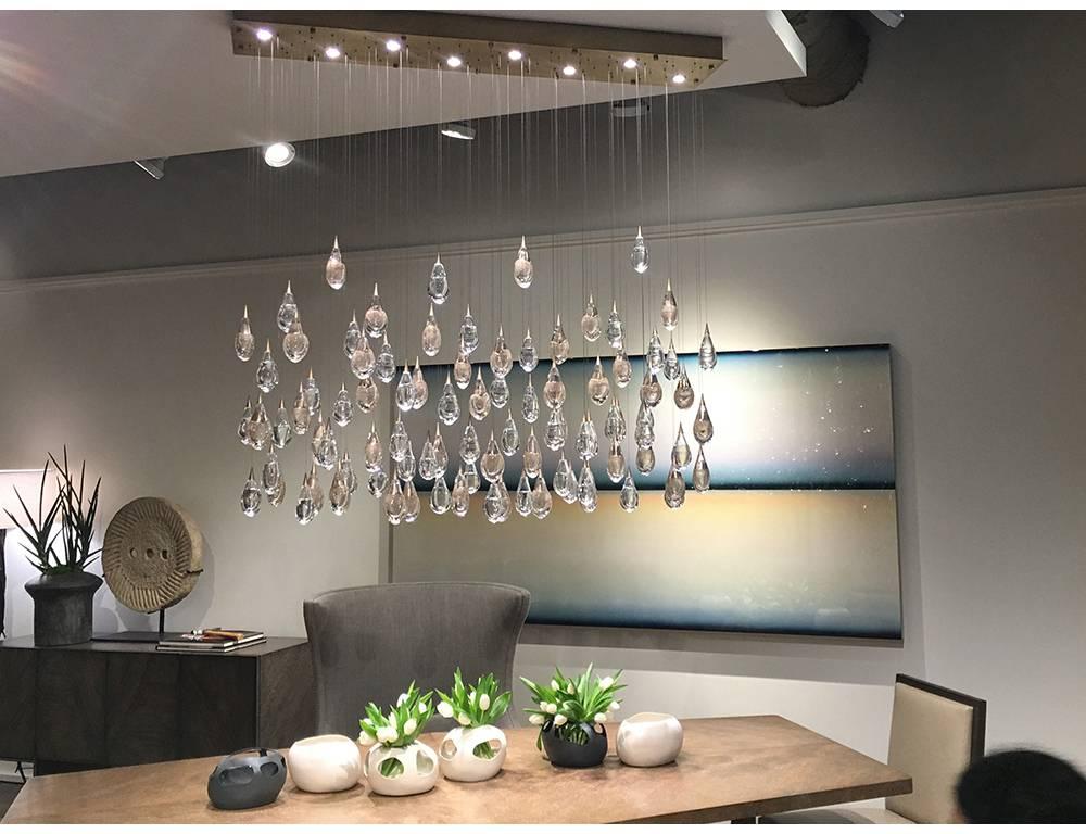 Optically rich glass drops perfectly captures the light from the above LED illuminated canopy. The thick double layer of glass acts like a lens which sparkles and shimmers with a liquid- like effect.

Measures: 60” x 12” x 65” H, 
Standard is all