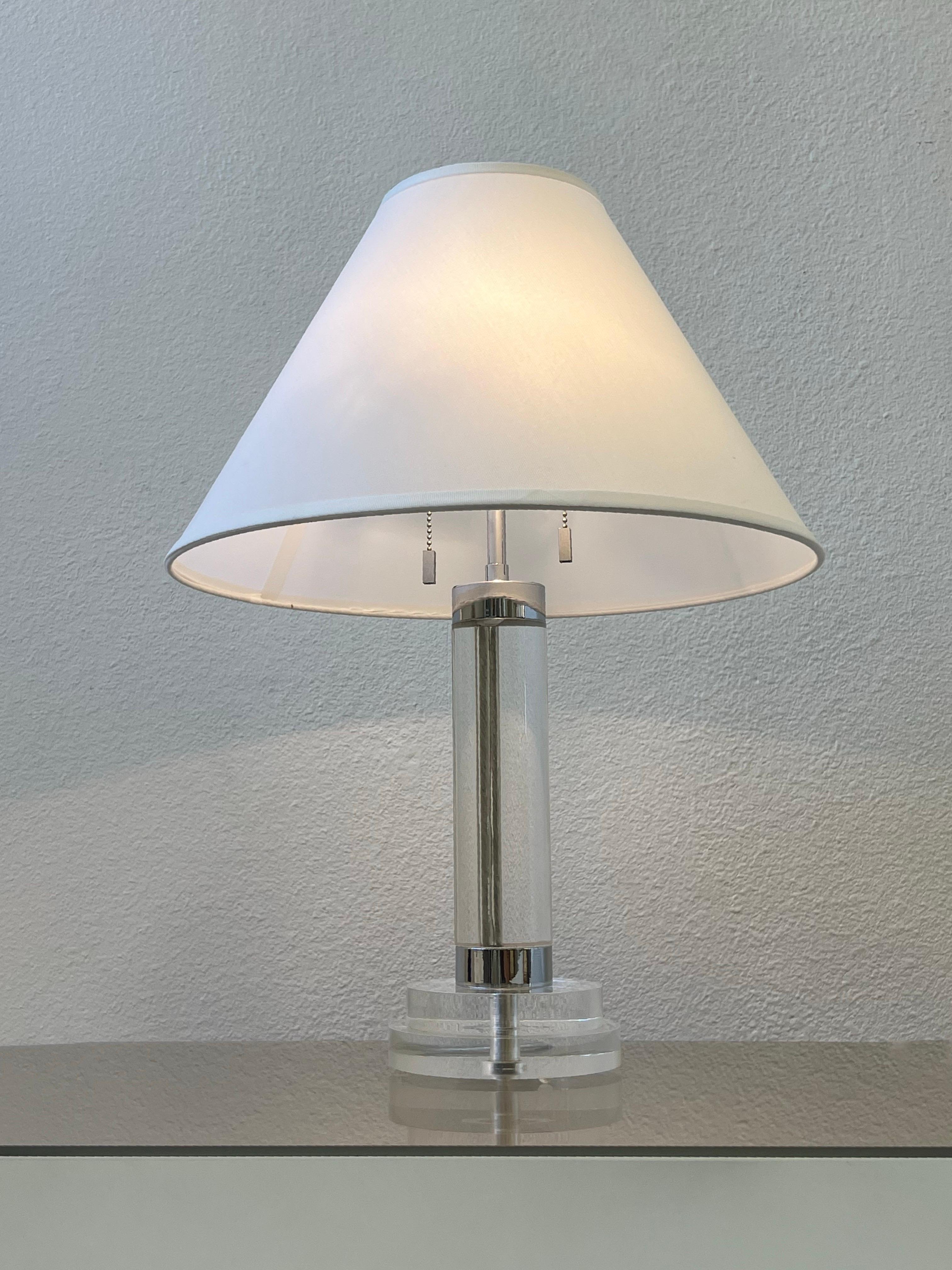 1980s Clear acrylic and polish chrome table lamp by Karl Springer. 

Newly rewired and new shade. 
It takes two 75w Max Edison lightbulbs.

Measurements: 17” Diameter, 6” Diameter Base, 22.75” High.