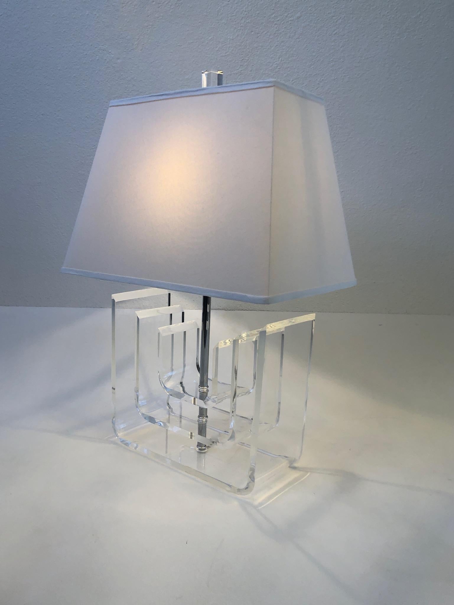 Glamorous 1970’s clear acrylic and polish chrome with a off white linen shade by Marlee.
Hand signed by Marlee.
It takes one 75w max Edison lightbulb. 
Measurements: 18” wide, 12” deep, 26” high.
