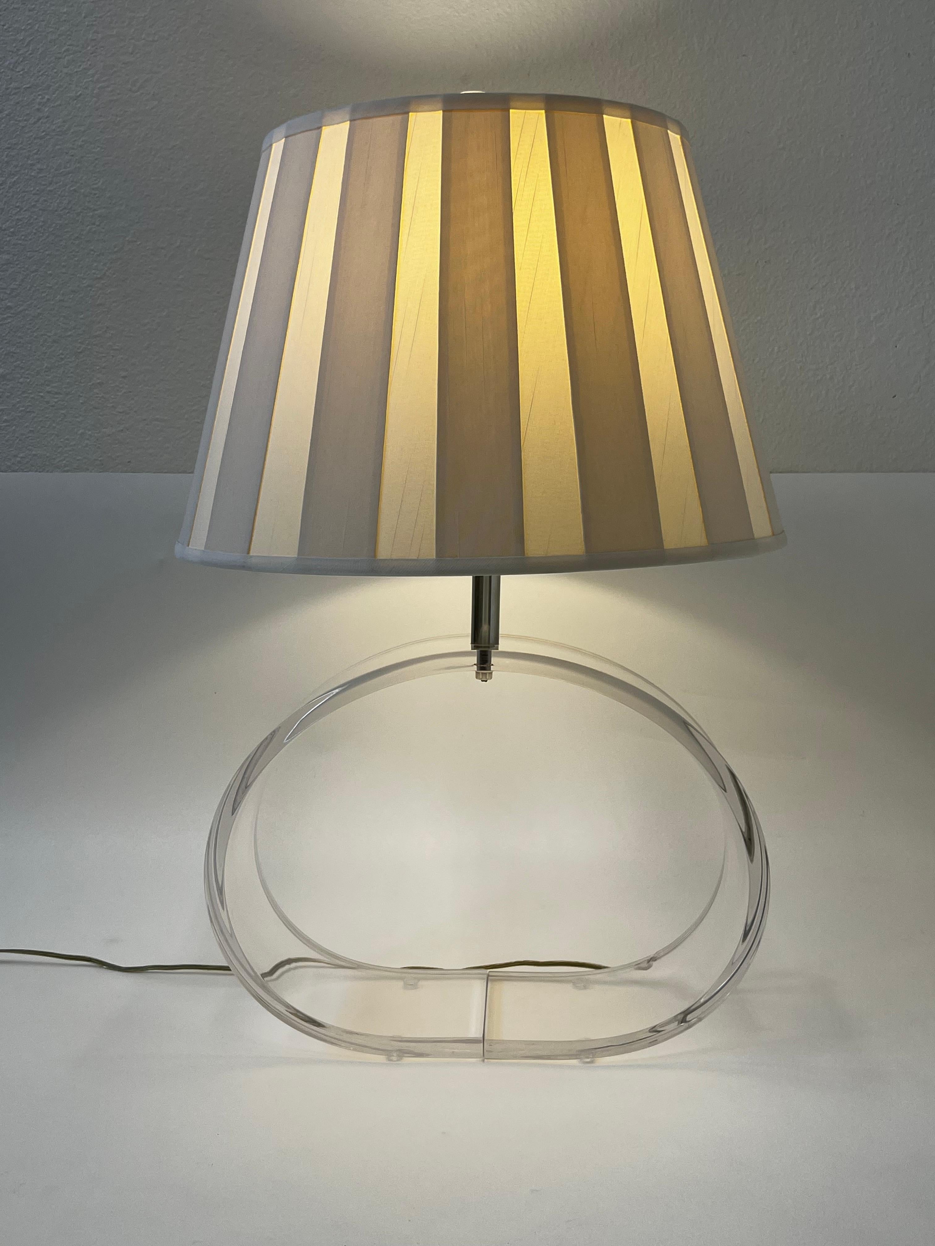 1970’s  oval clear lucite and chrome table lamp with original pleated silk shade design by Ritts Co. 

In good original vintage condition. 
It takes one 100 max Edison lightbulb. 

Measurements: 26.5” High, 16.6” Wide, 5.5” Deep,
Shade is 18”