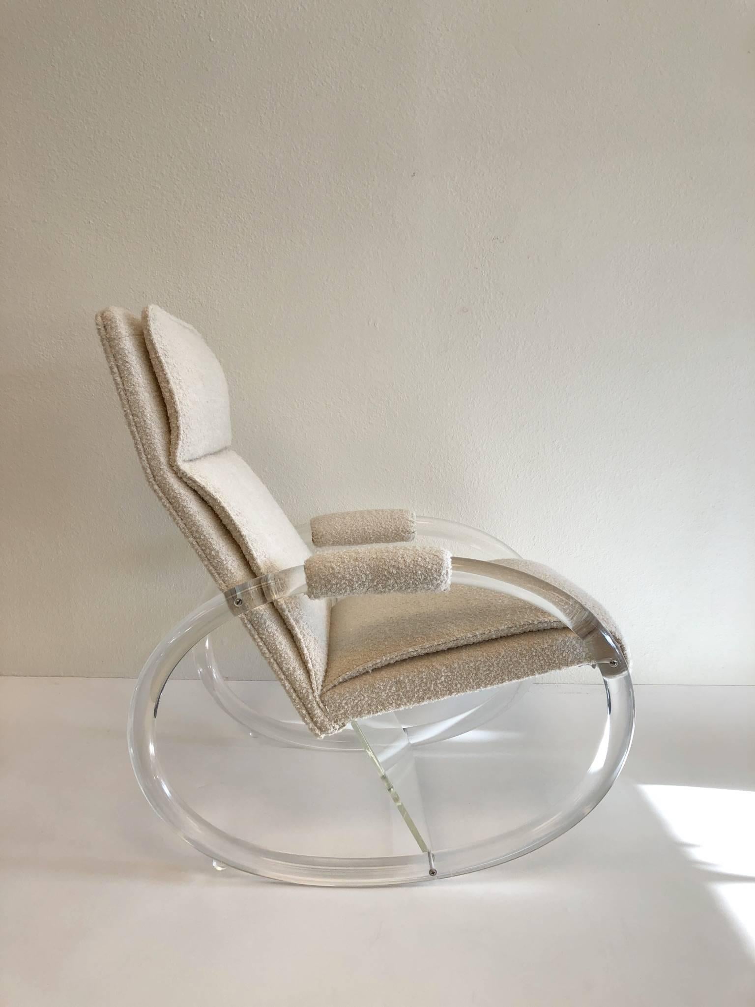 A glamorous clear Lucite and fabric rocking chair. The chair was designed in the 1970s by renowned designer Charles Hollis Jones. Newly reupholstered with an off-white thick soft nubby fabric.
Dimensions: 36” high, 18.5” seat, 36” deep and 25” wide.
