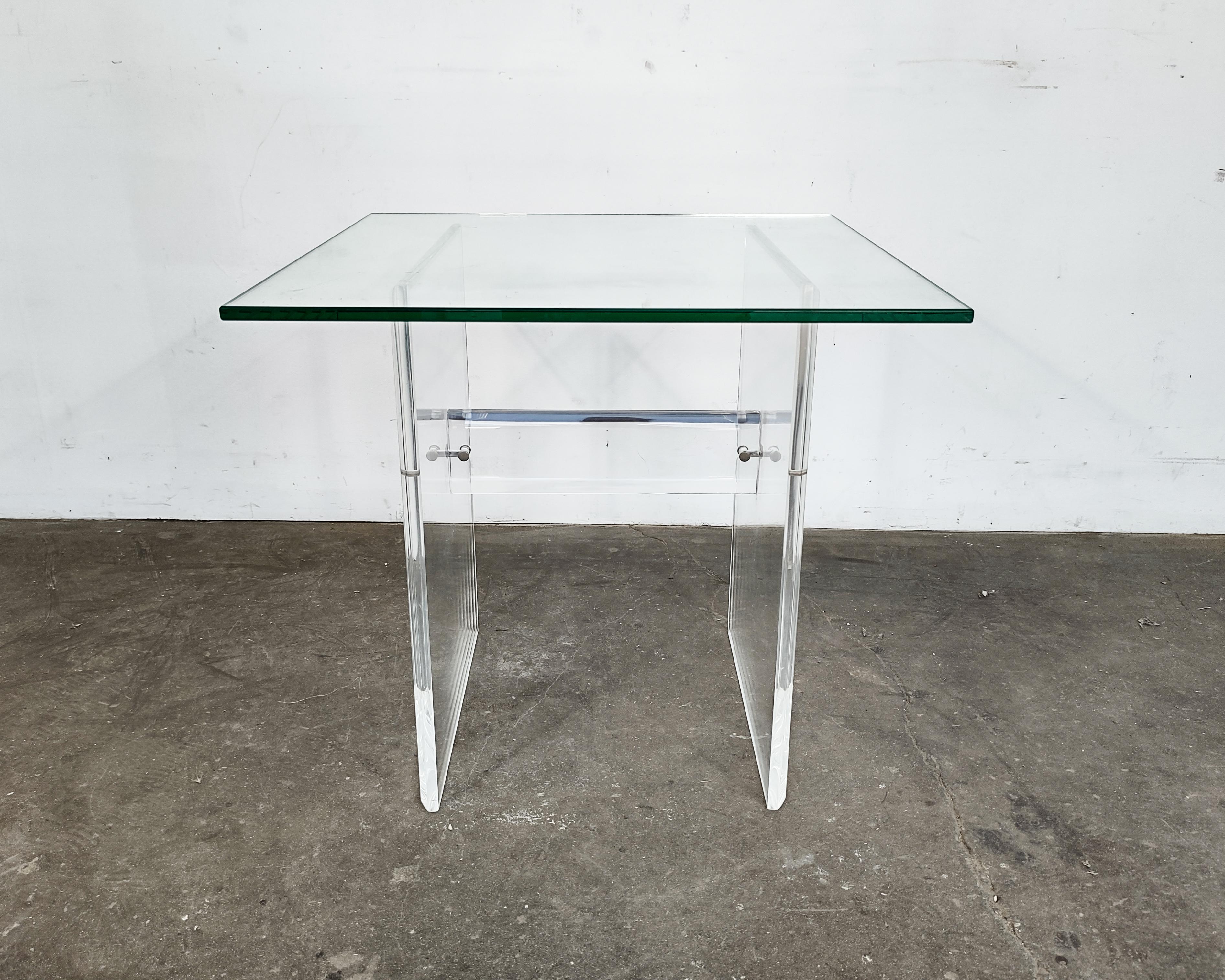 Thick lucite acrylic base with beveled edges and square glass sits on top circa 1970s-80s. Overall great condition, some light scratches on glass. The base is held together by hardware and pieces can pivot when it's by itself, once the glass top is