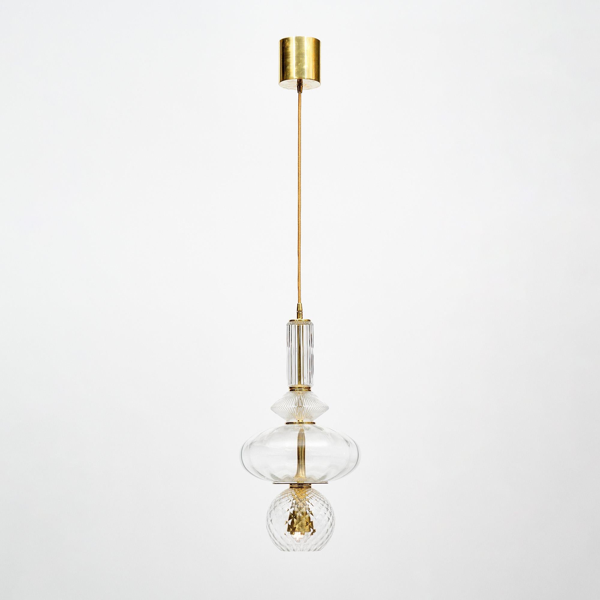 Murano glass pendants in the style of Ettore Sottsass. This pair features elements of hand-blown glass all transparent and showcasing the clarity Murano glass is known for. Each piece of glass demonstrates a different texture. The glass is supported