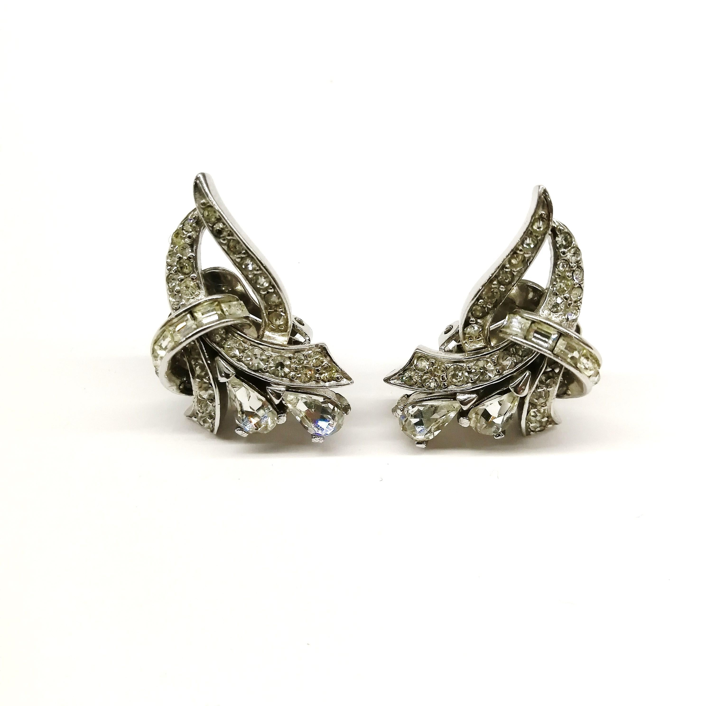 Smart and very wearable clear paste earrings, from Marcel Boucher, in the 1950s, in the design of an elegant 'arabesque' up the ear, very 'real' in their look. 
A beautiful addition to any wardrobe, or a beautiful Seasonal gift.
Marcel Boucher