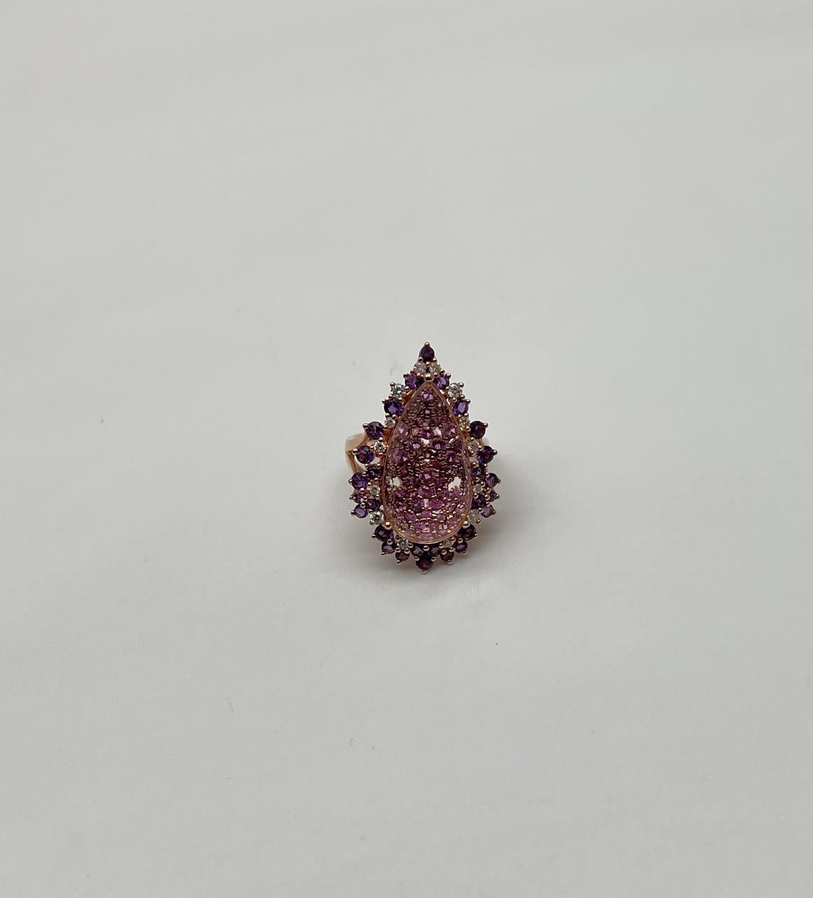 A fusion of elegance and brilliance.

This striking ring showcases a teardrop-shaped clear quartz, adorned with a mesmerizing array of sparkling sapphires, amethyst and diamonds.. The central gem is encircled by a halo of deep purple amethysts and