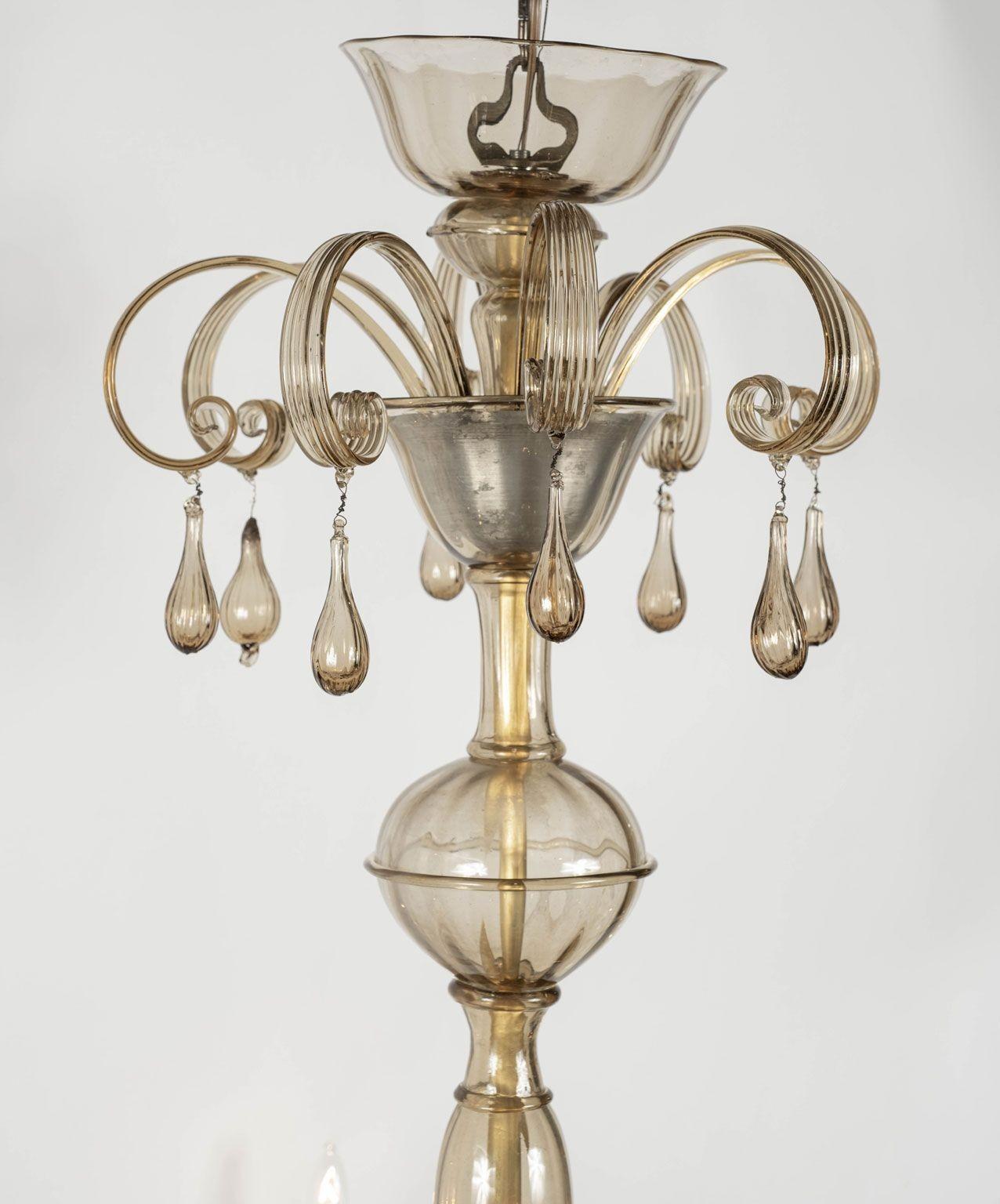 Clear taupe color glass Murano chandelier circa 1930-1949. Clear glass tinted a taupe-champagne-nicotine color. Includes chain and canopy (listed height does not include chain).