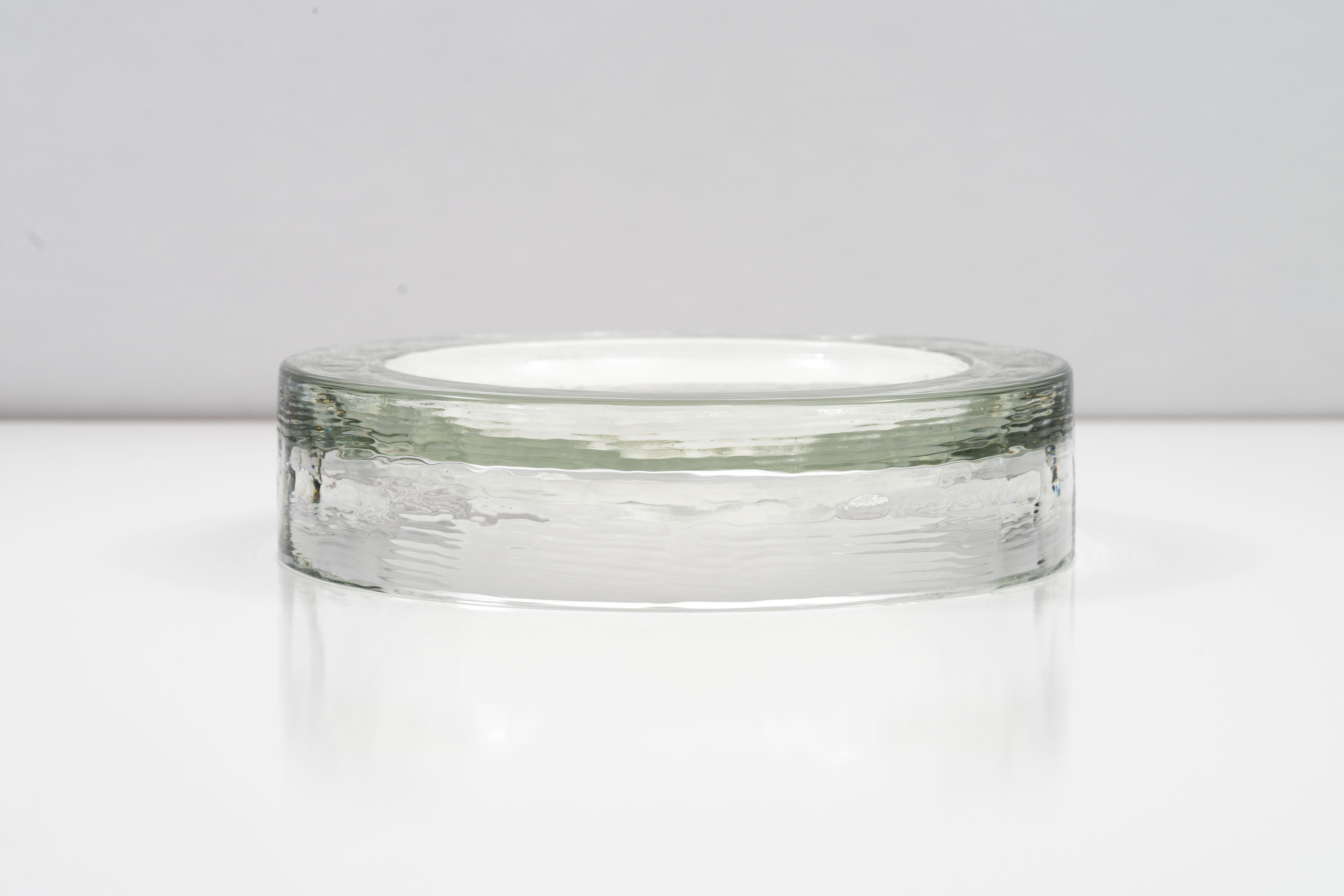 Substantial low textured clear glass dish by Barbini Murano from the 1970s. The cast glass dish is suspended inside thick 1.5cm walls. Beautifully catches the light to create patterns on the surrounding surface. Incised 