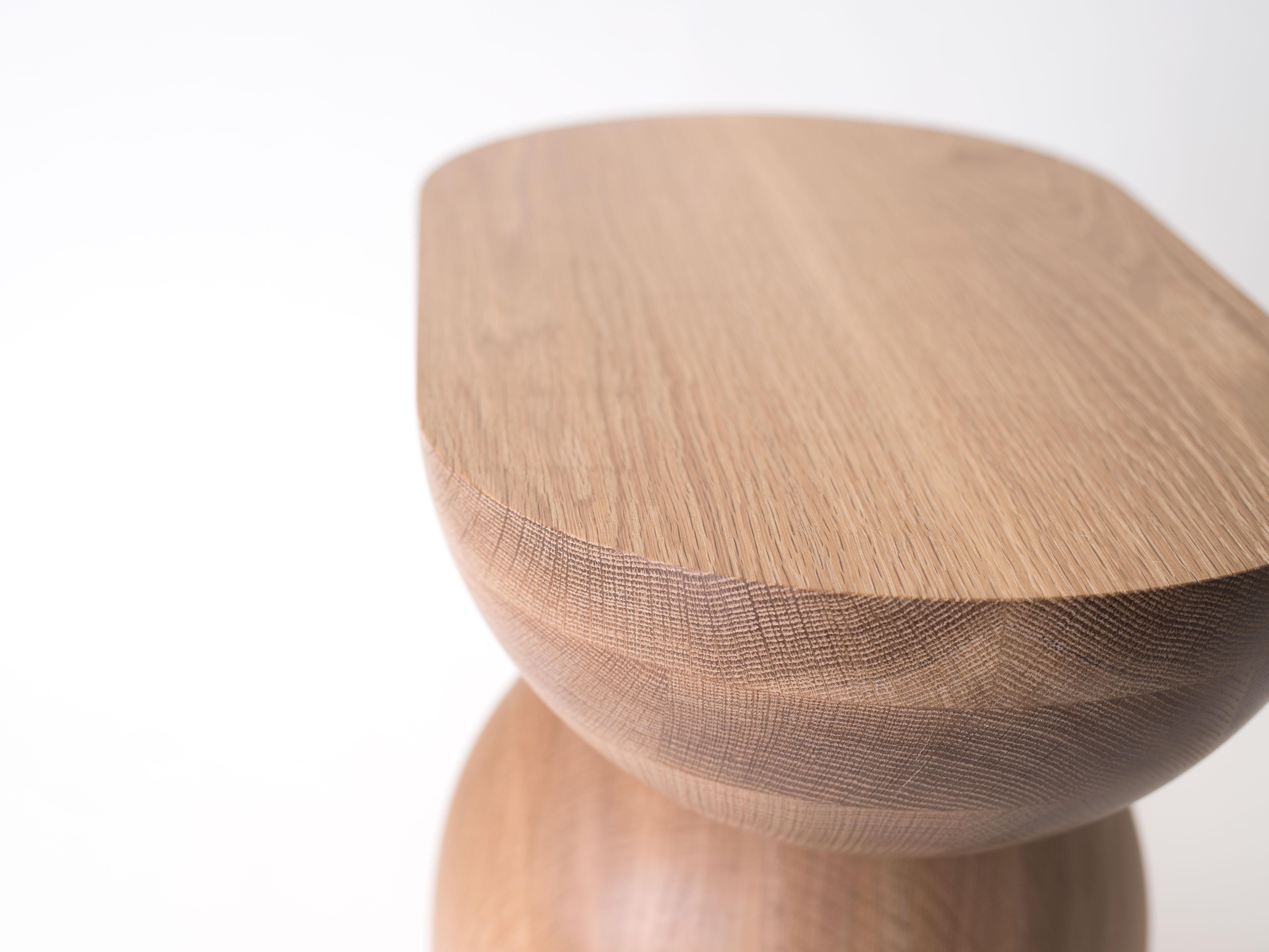 The Cleave side table is handcrafted out of solid white oak. The Cleave is built by gluing two chunks of oak together with a layer of paper between. After handing turning it into shape, it is 