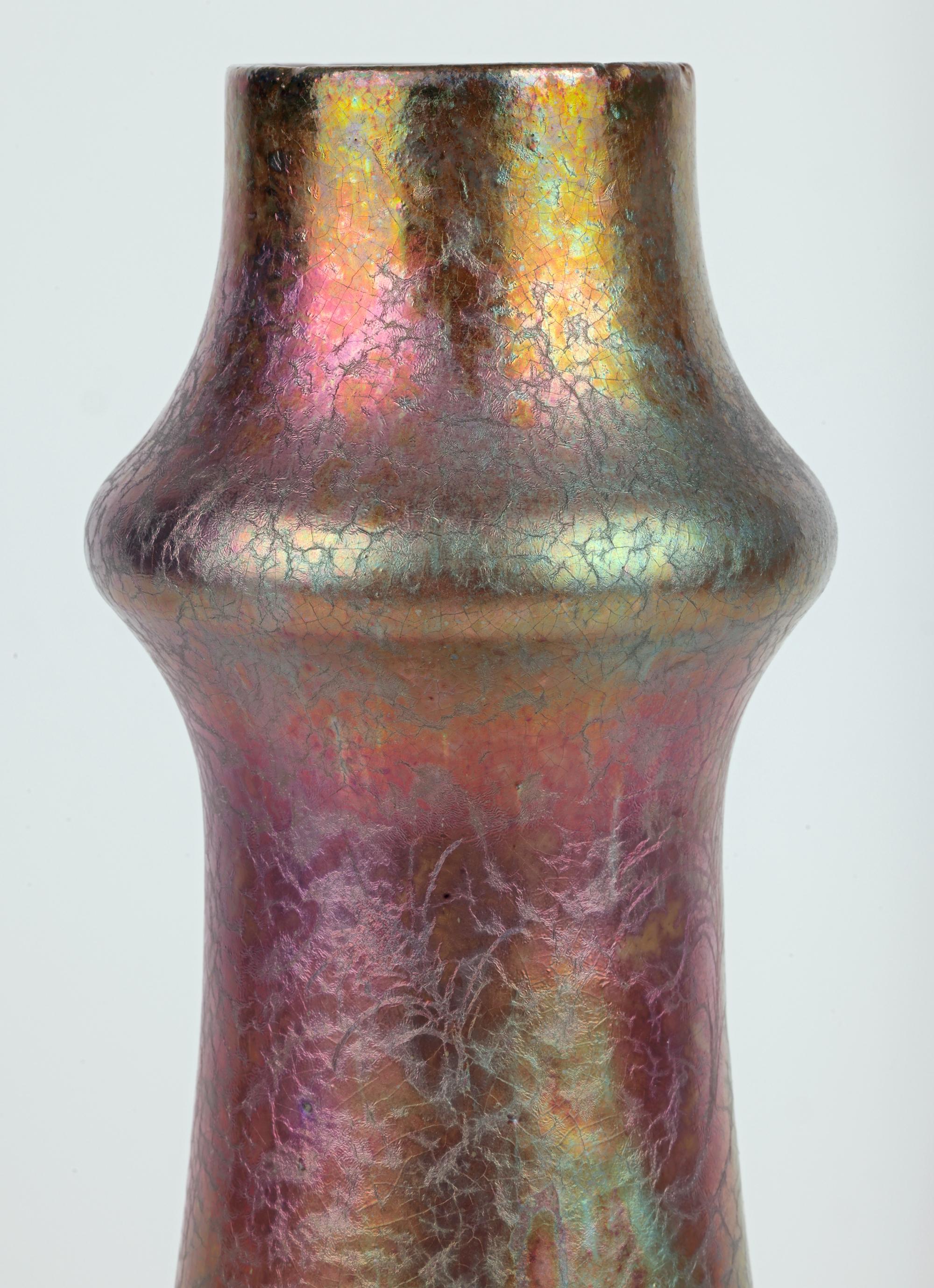 A large and stunning Art Nouveau peacock feather design art pottery vase decorated in iridescent glazes attributed to renowned French ceramic artist Clement Massier (1845-1917) dating from the latter end of the 19th century. The tall funnel shaped