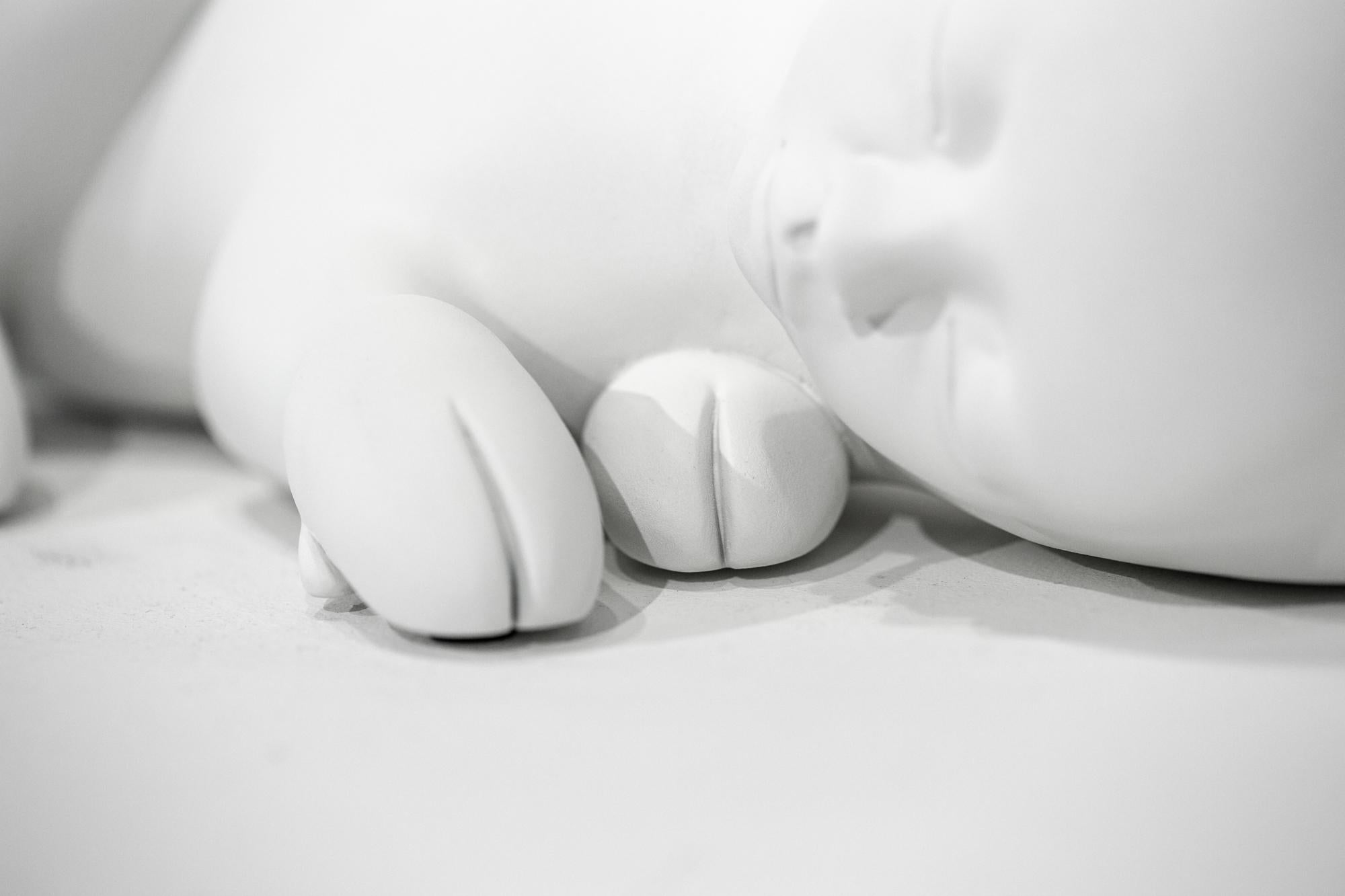 This white figurative sculpture titled 