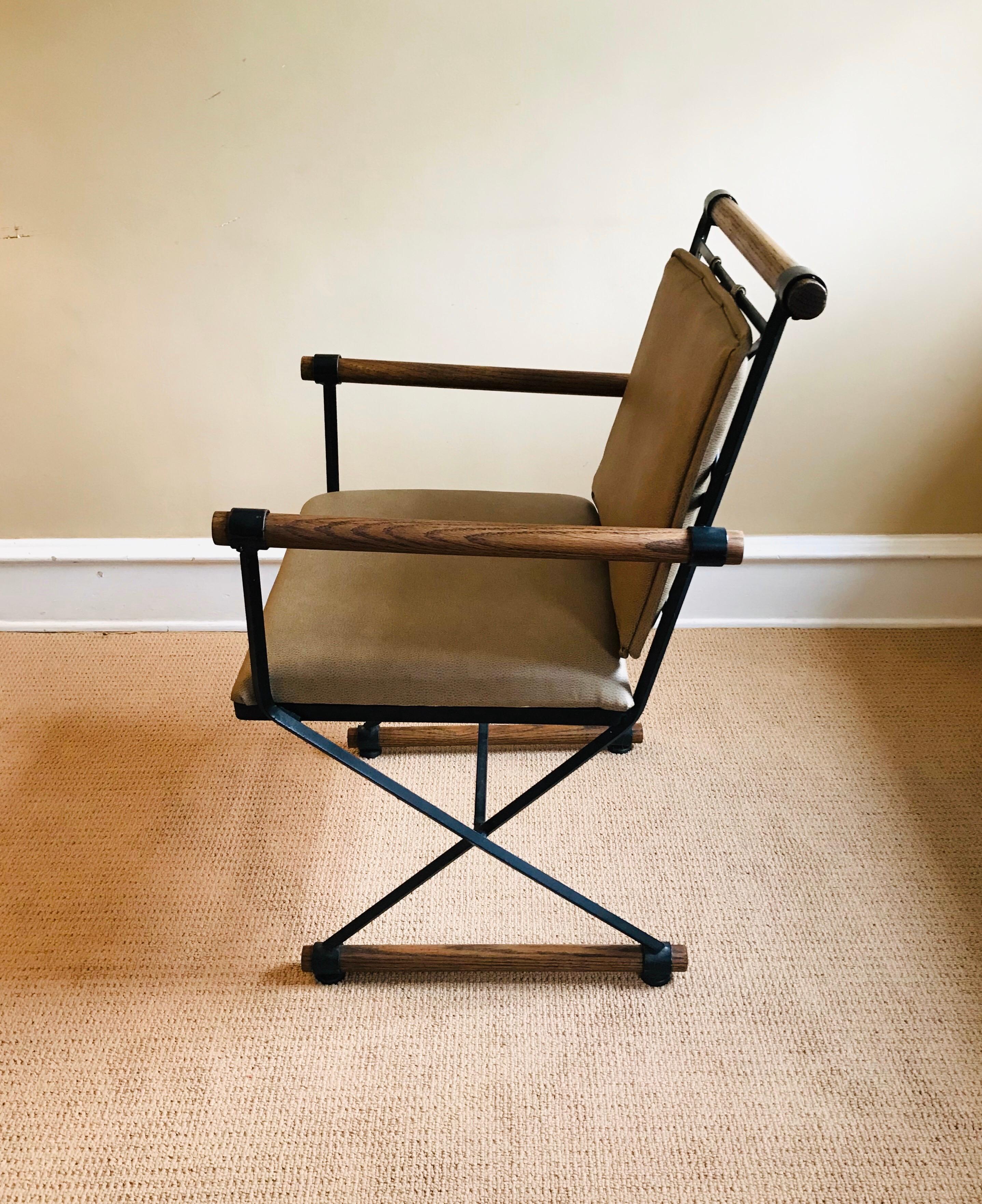 Handsome iron and oak directors chair. Upholstery is in a textured taupe material. Chair is substantial and is in beautiful condition.