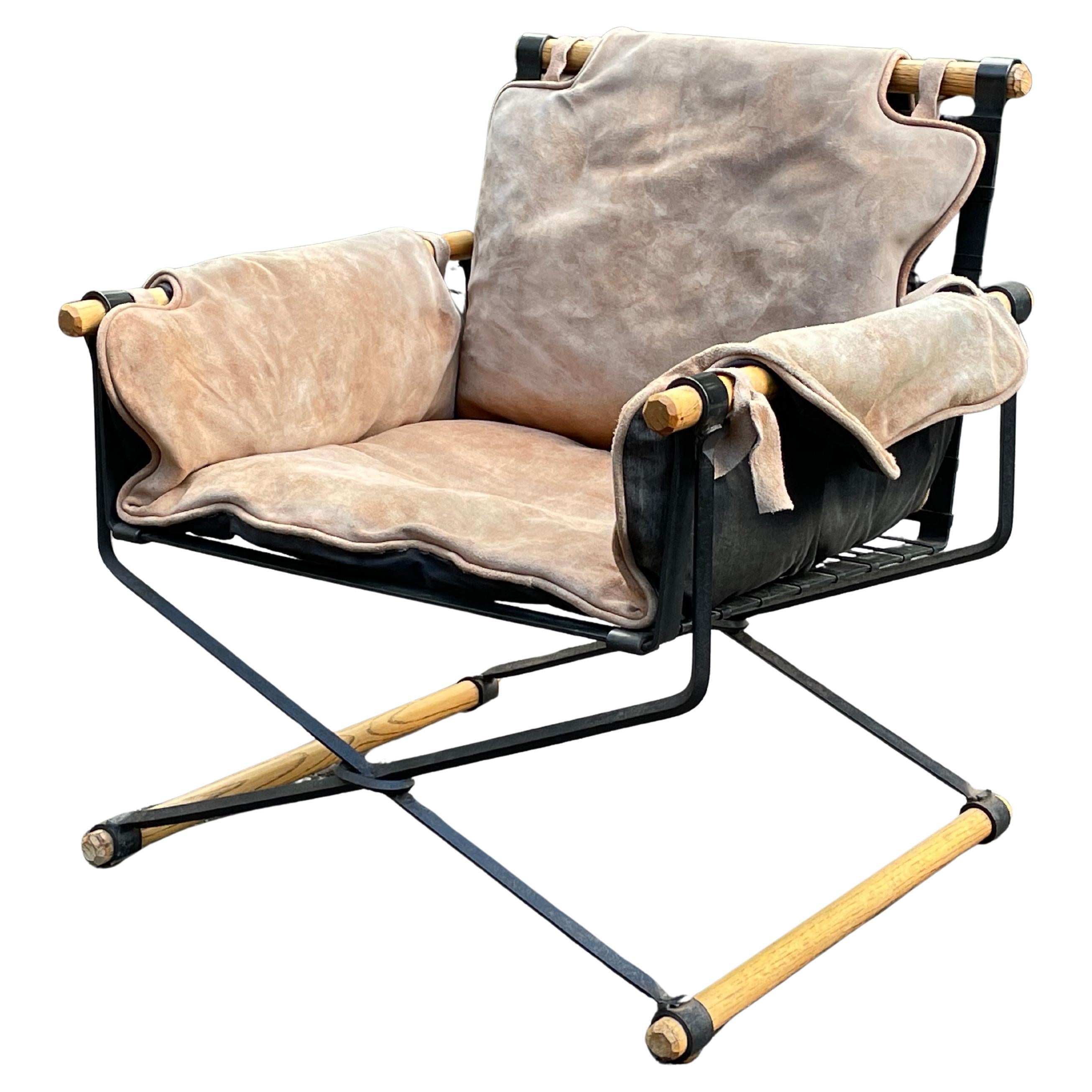 1950s Mid-Century Cleo Baldon Oak and Iron Lounge Chair in Suede. Circa 1950s.

Rare design by Cleo Baldon for Terra. This example has Baldon's unmistakable iron work with solid oak rod detailing and is upholstered in a brown suede and black
