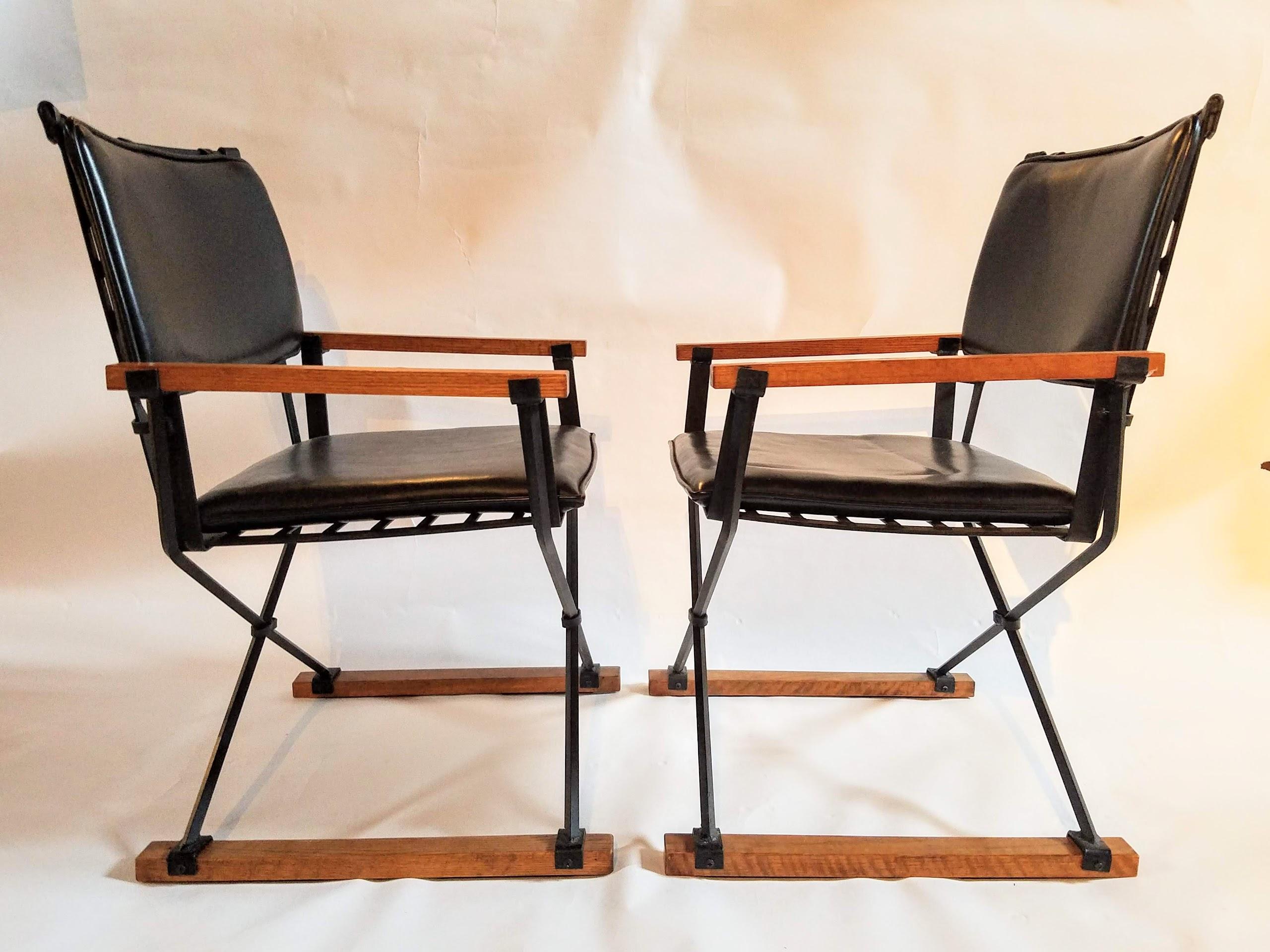 Cleo Baldon unusual pair of Campaign chairs manufactured by Terra in the mid-1960s thru the mid-1970s.
The wrought iron chairs are lacquered in their original black color with fumed oak strips and clip on back cushions.
This pair of chairs closely