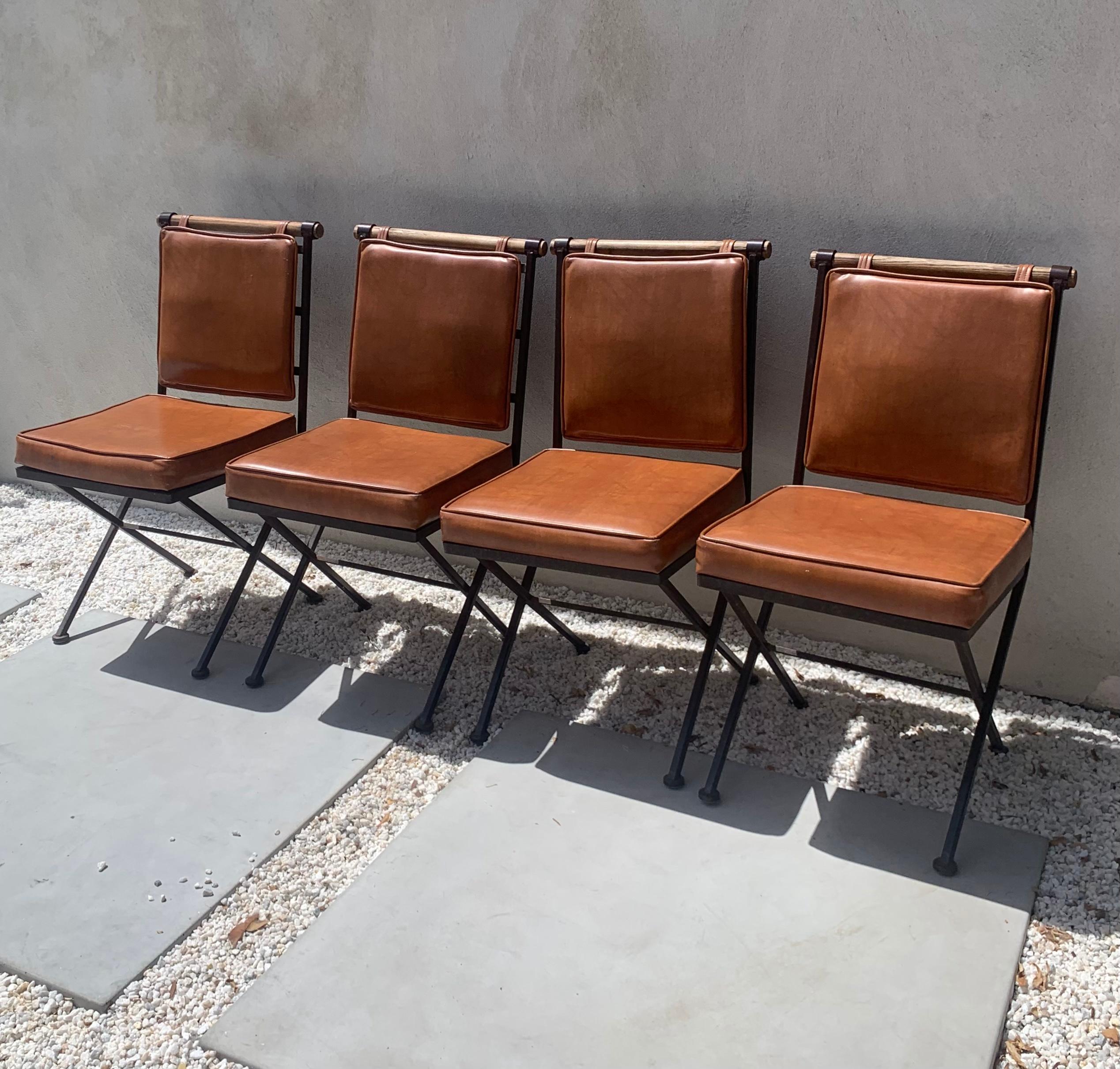 A set of four Cleo Baldon style dining chairs by Inca, mid 1960s. Iron, oak, and leather in a rich saddle hue. Some minor wear to material (see photos); overall great vintage condition. Pick up in LA or delivery options available.

Measures: 16” W