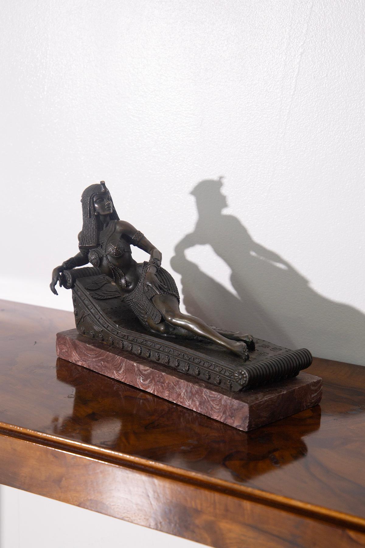 Bronze Statue of Cleopatra Reclining on Red Marble Base - Classical Sculpture of Great Charm
This elegant bronze statue depicting Cleopatra in a reclining position is an extraordinary celebration of the most iconic Egyptian queen in history. Crafted