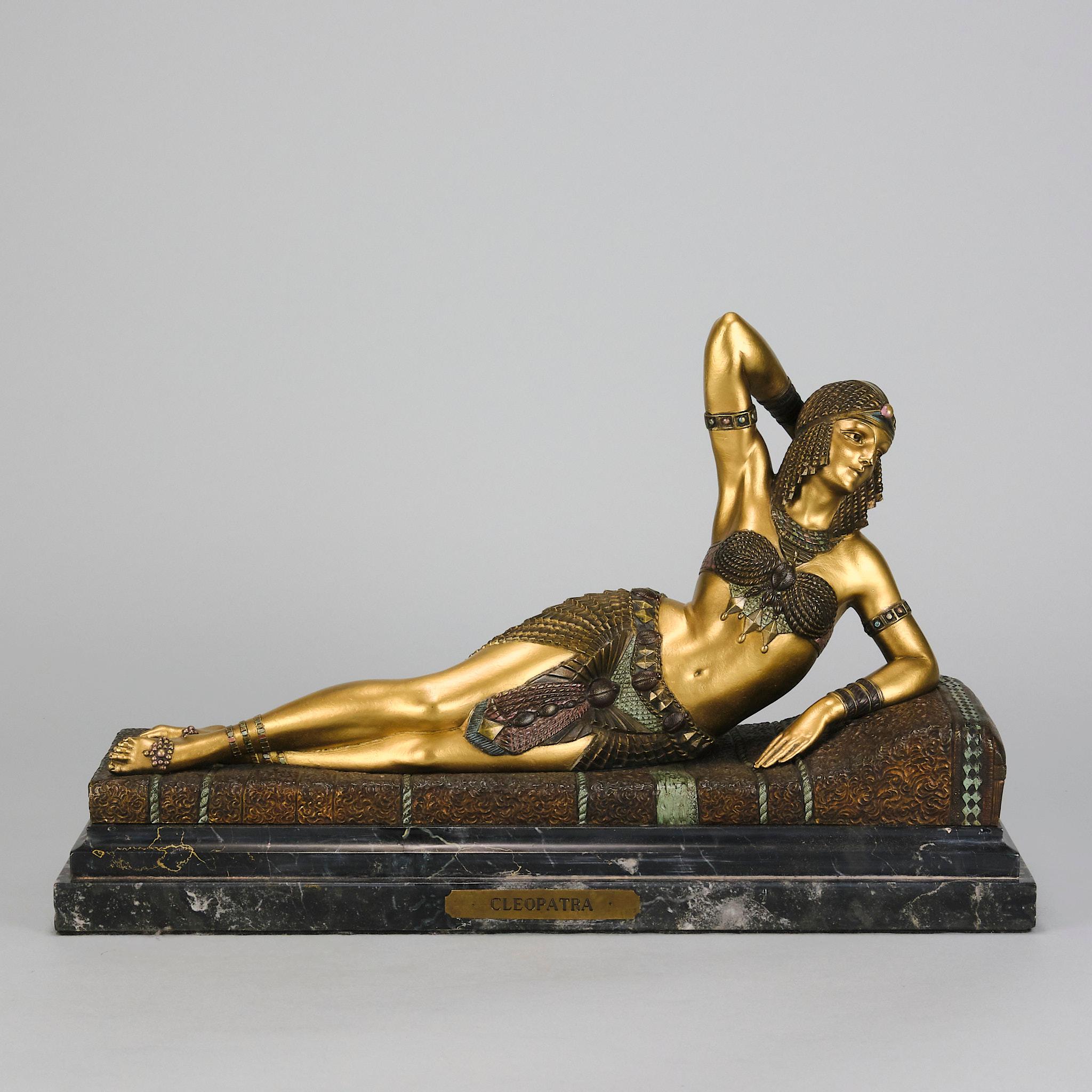 A dramatic early 20th century Art Deco cold painted gilt bronze figure of the reclining Cleopatra in full Ballets Russes costume, raised on a fitted marble base, signed Chiparus

Additional information

Height: 25 cm

Width: 40