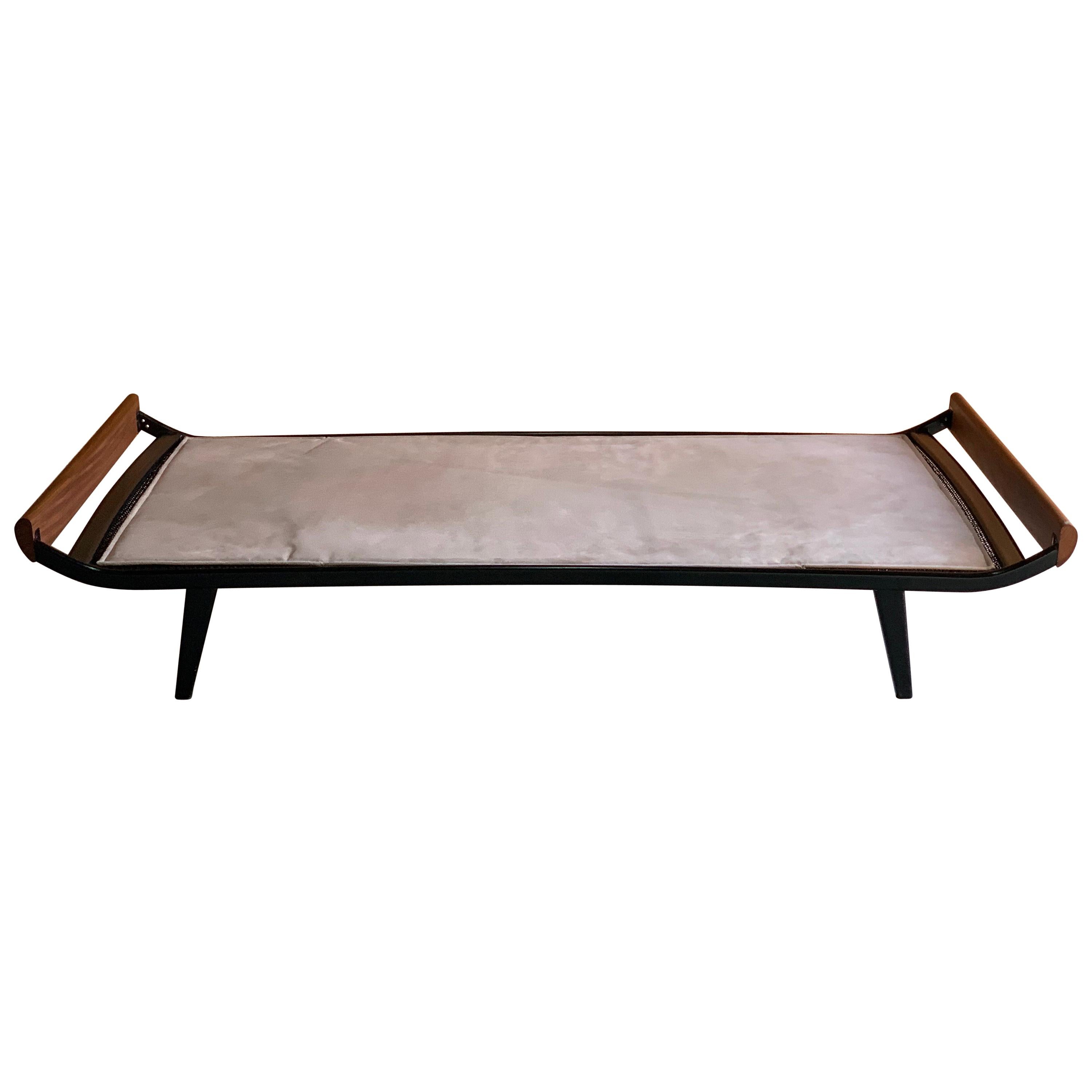 Cleopatra daybed by Dick Cordemeijer for Auping 1950s design.

Dick Cordemeijer for Auping ‘Cleopatra’ Teak daybed designed in1950, the Teak ends with black metal bed frame, the cream ultra suede mattress resting over a mattress topper on sprung