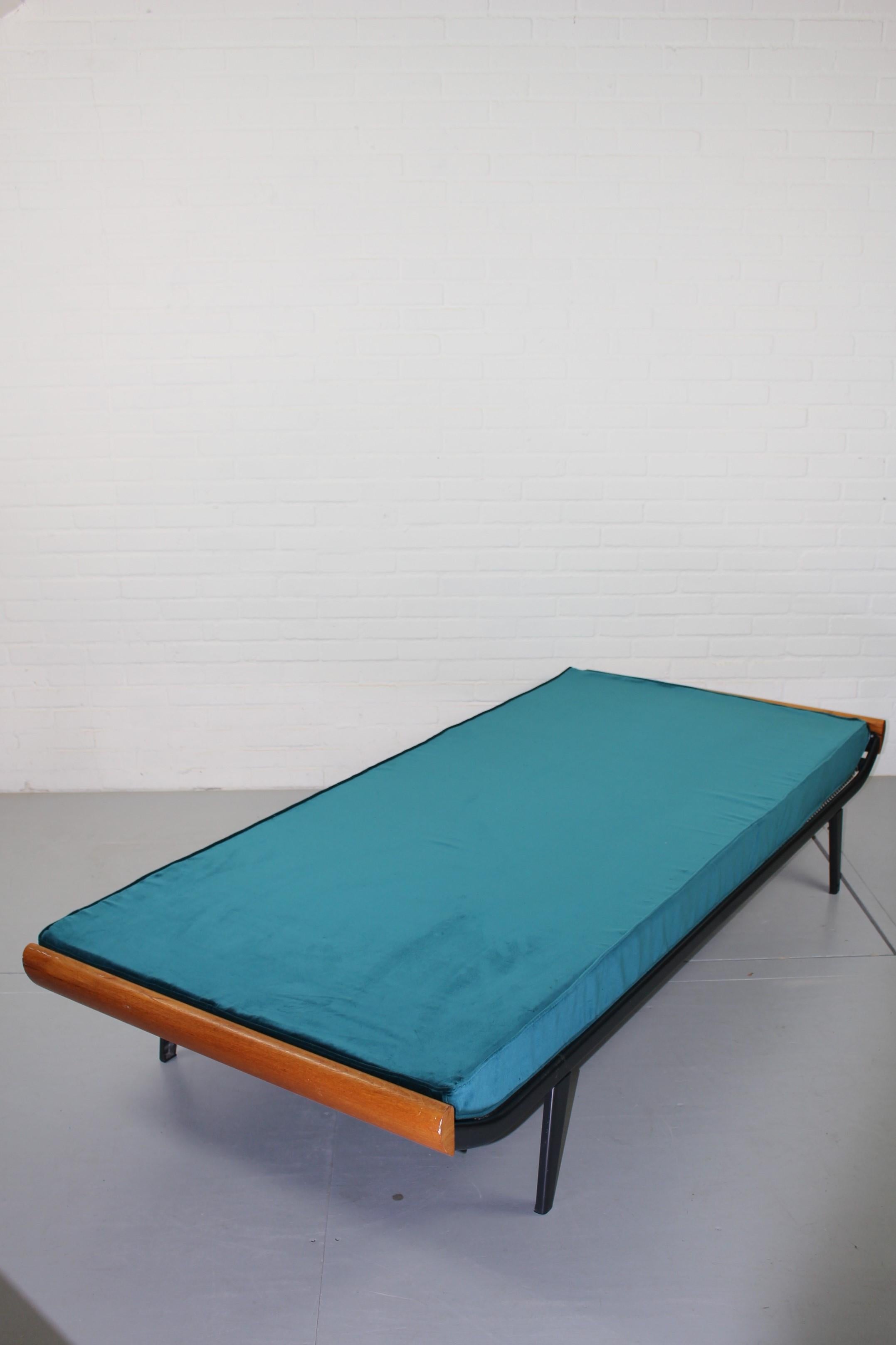 This Cleopatra bed was designed by Dick Cordemeijer for Auping in Holland, 1954. The frame was made from very dark grey coated metal with solid teak wooden tops. The new mattress has a new velours blue fabric.