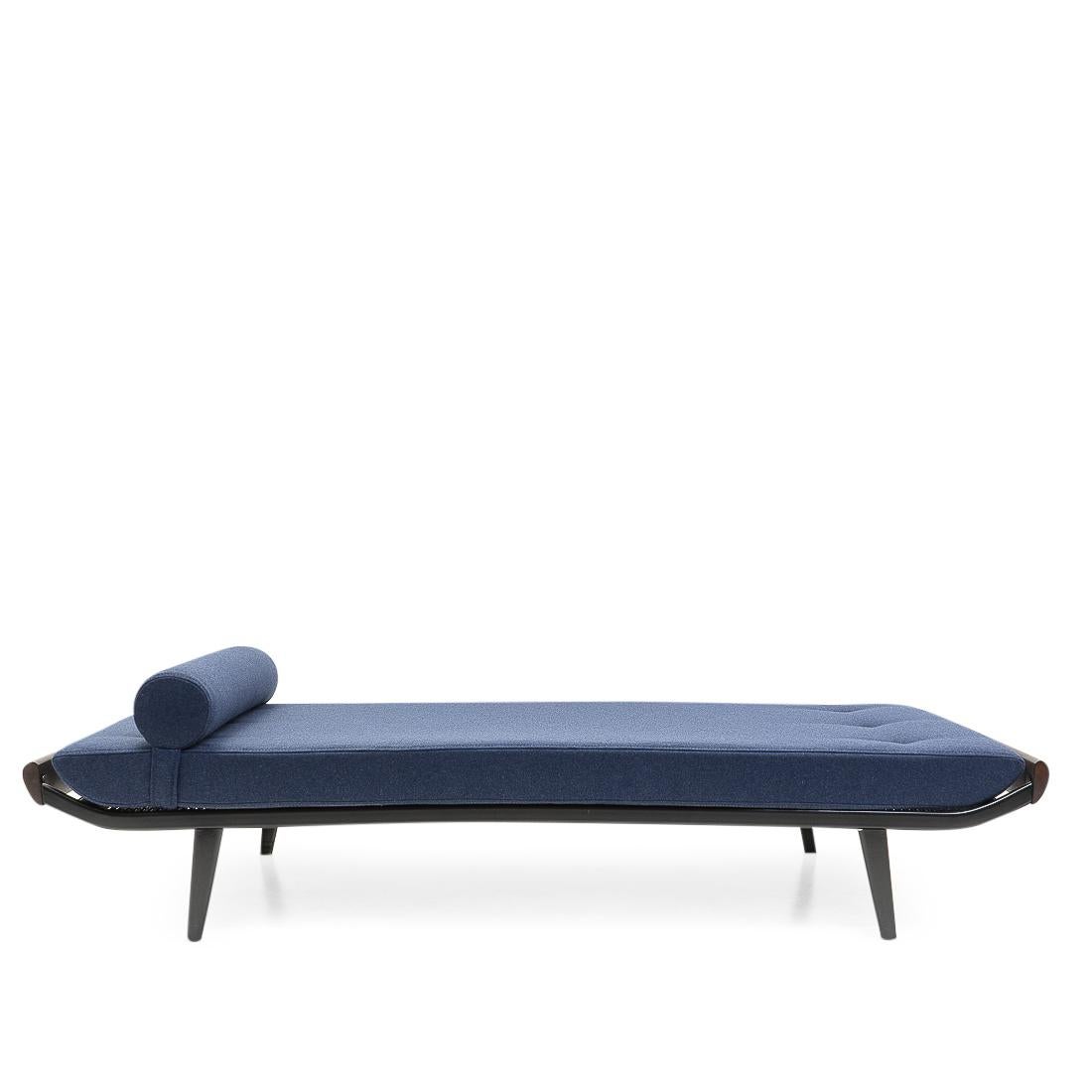 Vintage daybed designed by Dick Cordemijer for Auping (the Netherlands) during the 1950s.
New high-quality dark blue woolen upholstery and foam; the daybed can be used as both a sofa and spare bed. The cover features a zipper on both pillow and