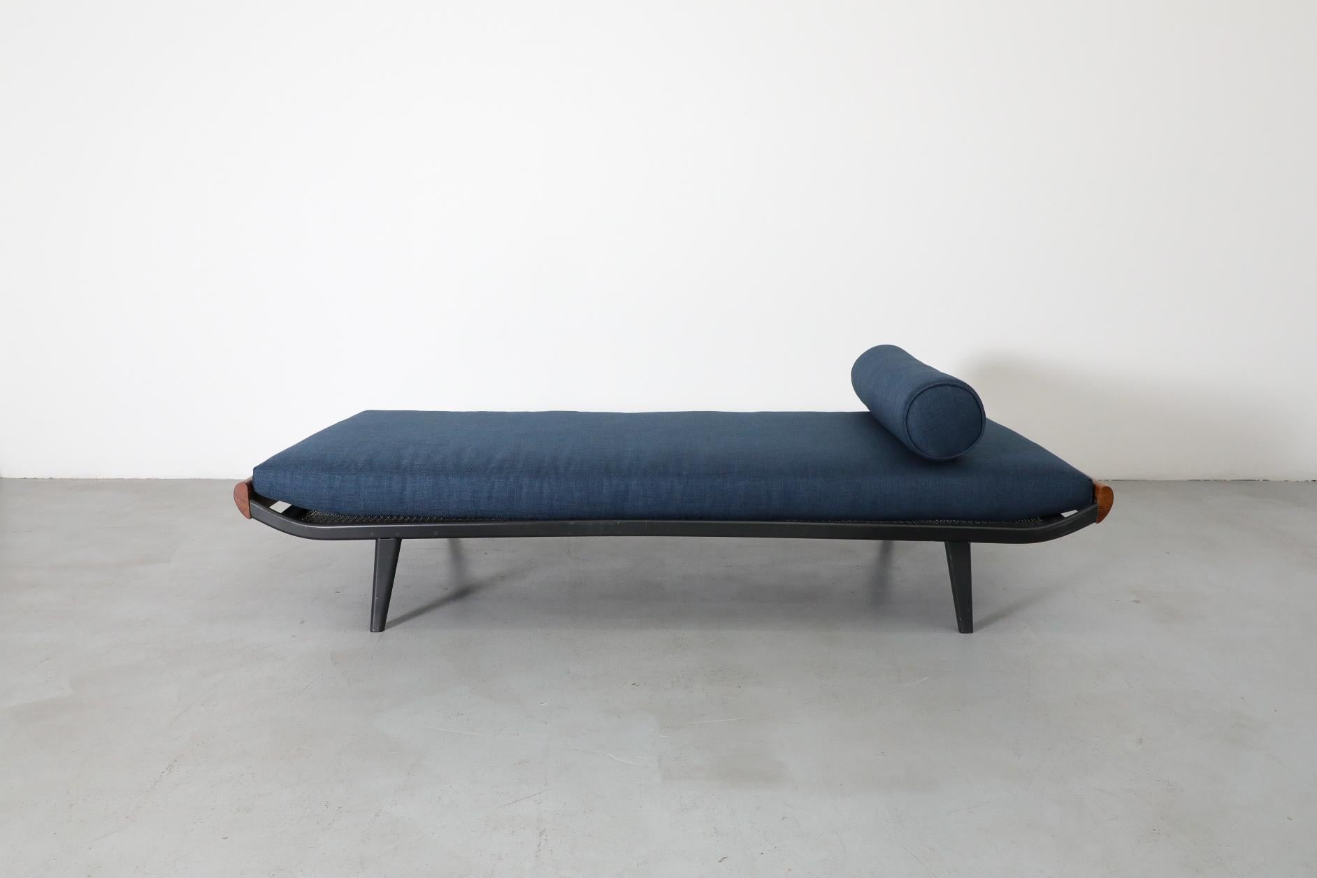 Mid-Century, 1960's Cleopatra daybed by A.R. Cordemeyer with teak ends, enameled metal frame and new blue mattress and bolster. Manufactured by Royal Auping the Cleopatra divan bed was developed by Cordemeyer in 1953 to fit in with the newly