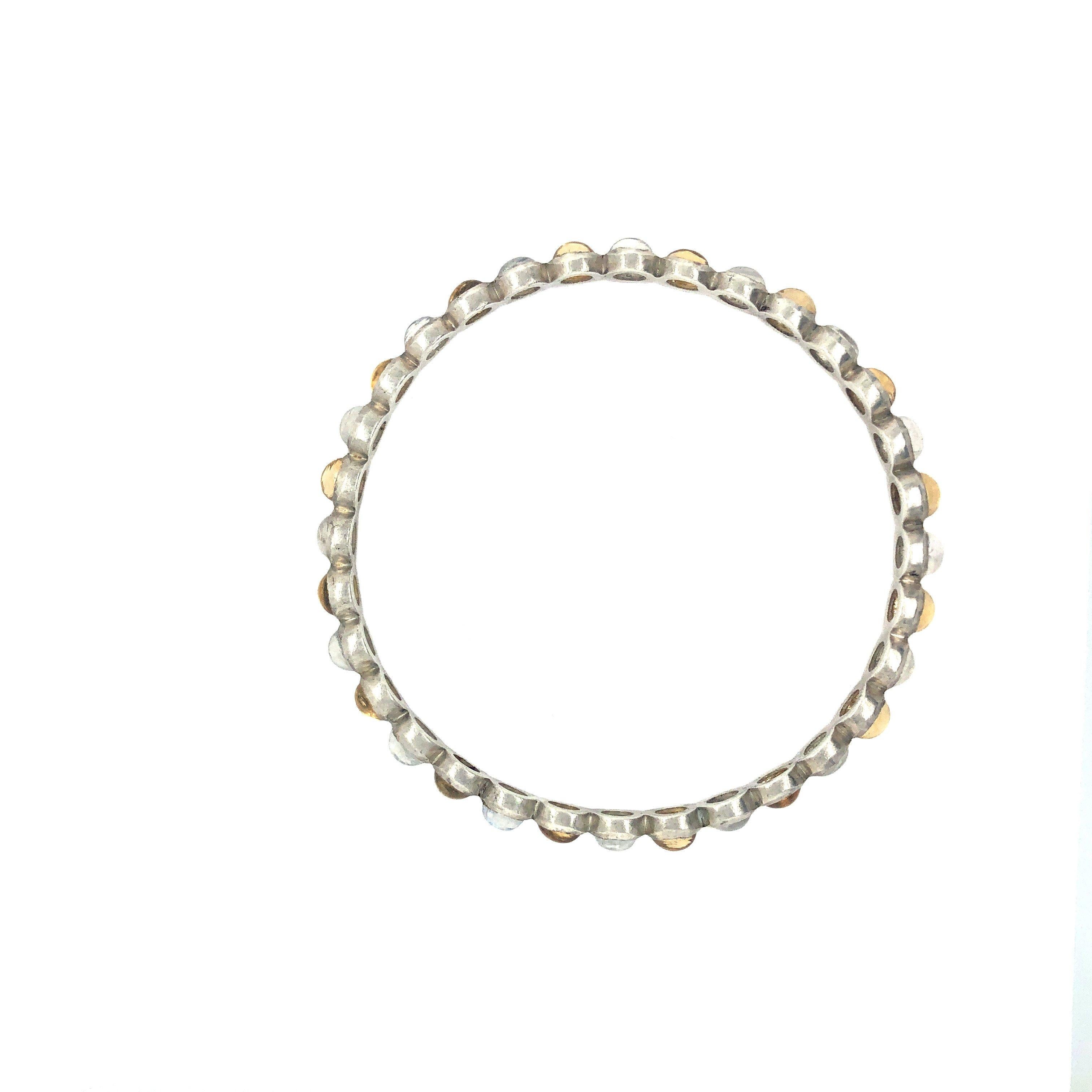 Timeless yet modern, this is a perfect accent, whichever color you choose. Semiprecious stones in a round bangle bracelet

One Size Fits All: Medium, 70mm diameter
Materials: Rainbow Moonstone with Lemon Yellow Citrine and Sterling Silver
