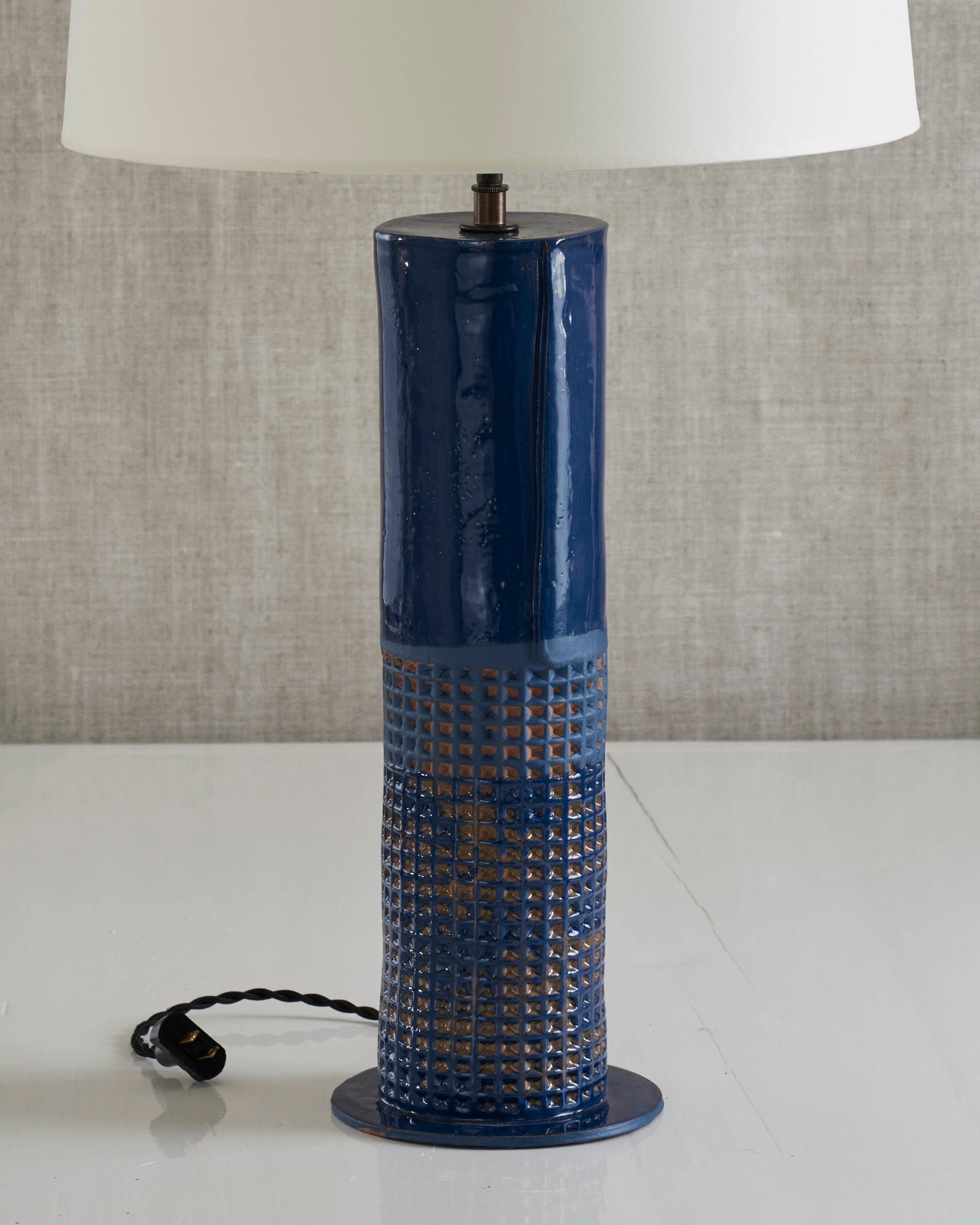 Handmade stoneware slab construction with waffle texture. Lamps are individually crafted and one of a kind.

Ultramarine glaze with waffle texture. Antique brass fittings with braided black silk cord and off-white paper shade.

Column height