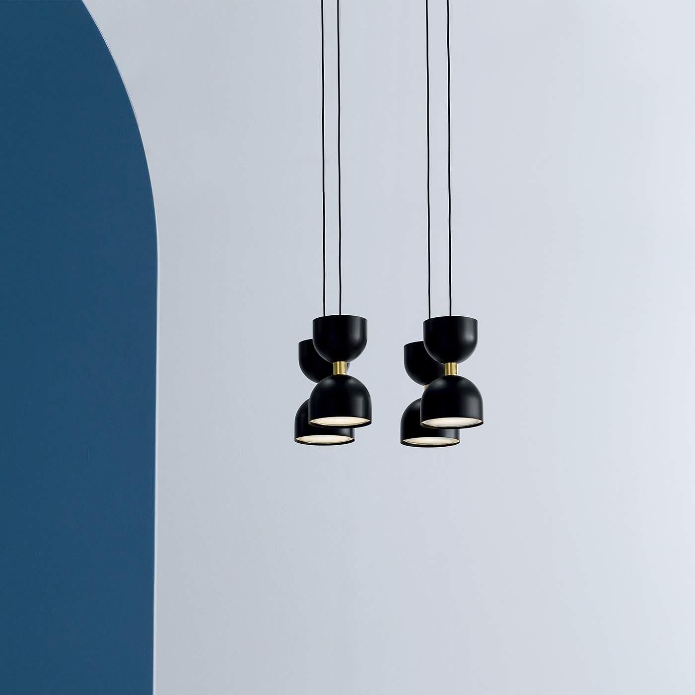 Part of the Clessidra collection, this modular composition of ceiling lamps is named after the Italian word for hourglass. The delicately rounded and symmetrical shapes of the four shades is crafted of metal with a black matte finish (also available