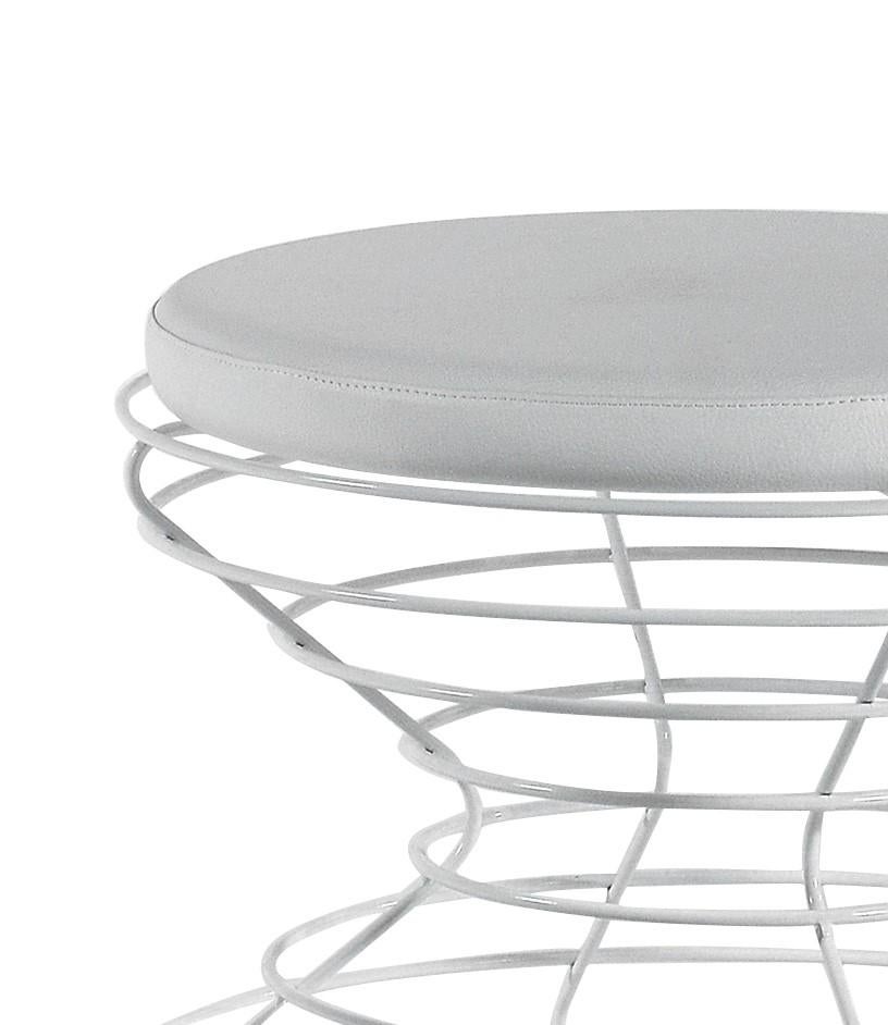 A modern piece of functional decor, the sculptural base of this pouf is handcrafted of iron wire rods fashioned into an hourglass-like shape and finished in lacquered white. A white, padded seat in ecopelle (recycled leather) rests on top the wire