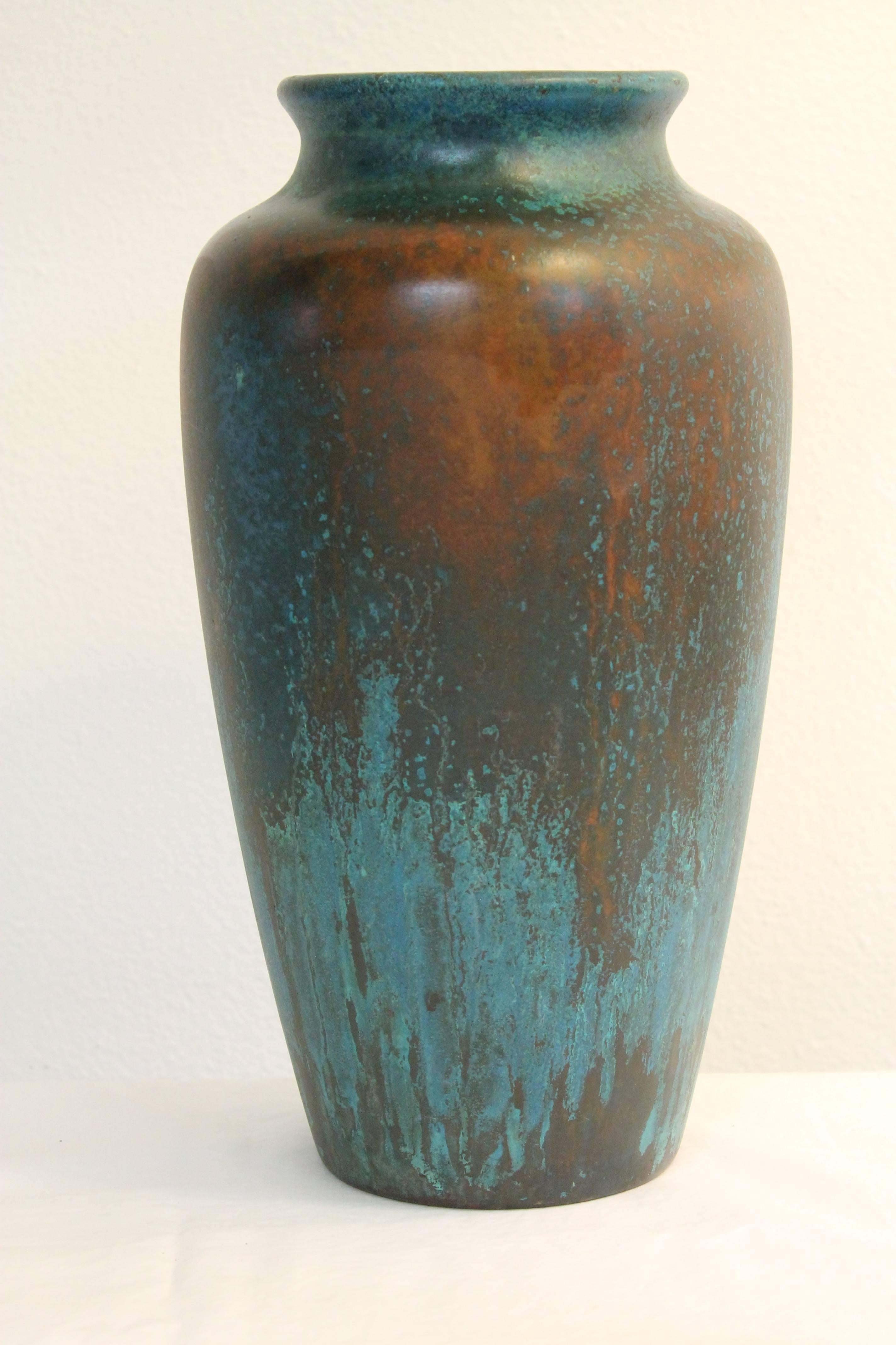 Vase by Charles Walter Clewell (1876 - 1965) of Canton, OH. Vase is copper clad and patinated. Clewell developed a secret technique for completely covering the exterior of a vase with a metal coating. Vase measures 14