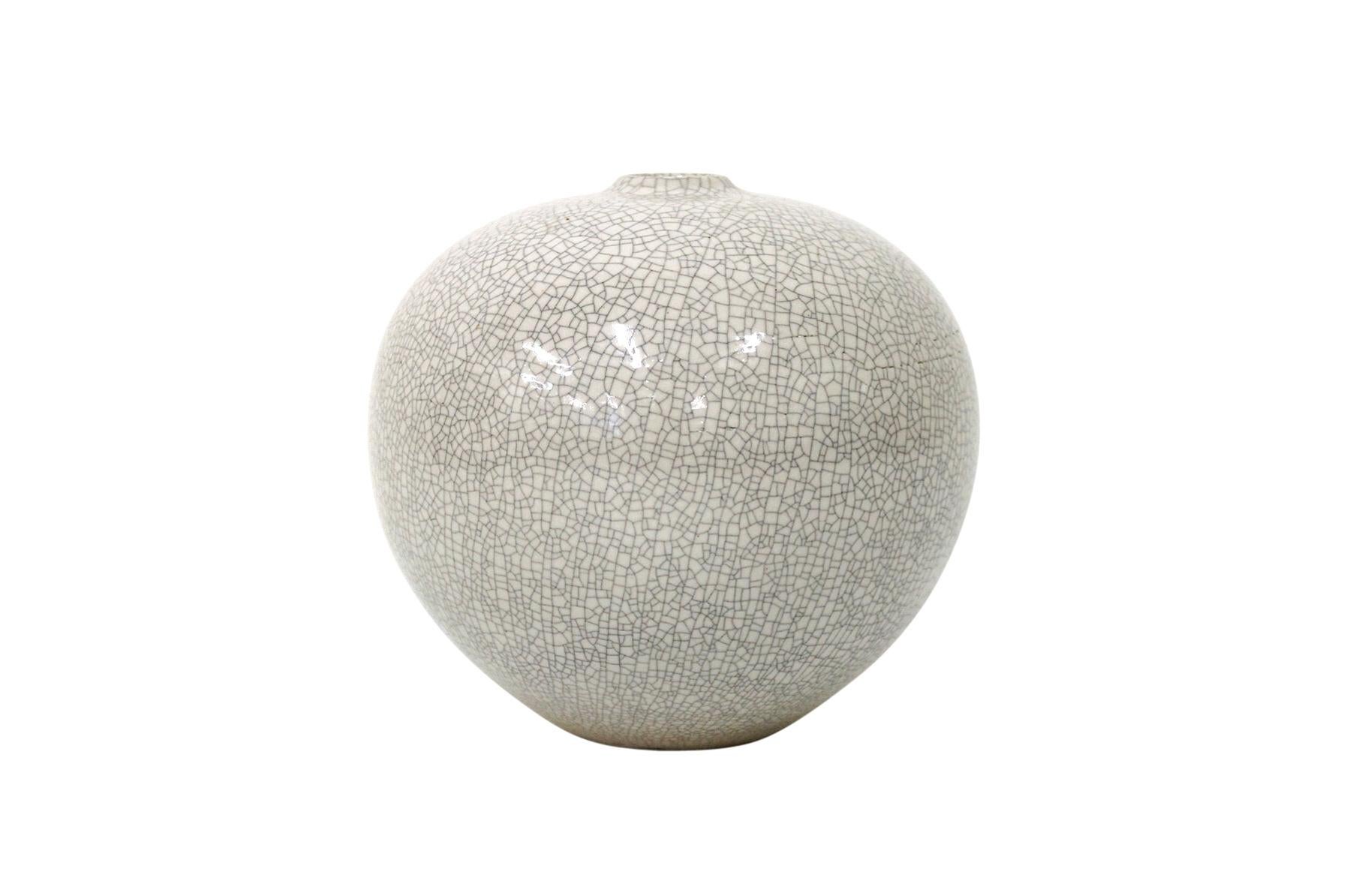 Spherical bone white vase by American ceramicist Cliff Lee. Lee is well known for recreating long lost Chinese glazes. This vase from the 1990s employs a refined and stunning crackle glaze.

____

We're offering our customers free domestic shipping