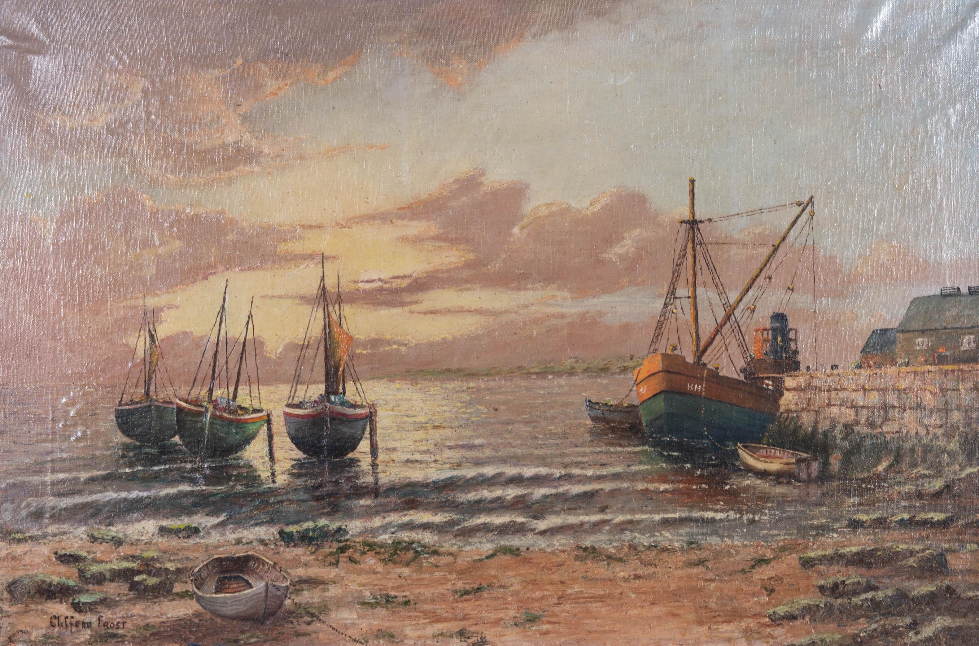 A pleasant seascape in oil by Clifford Frost, depicting a sunset beach scene with boats. Signed to the lower left-hand corner. The artist name and title are inscribed on the reverse. Presented in a white wooden frame, as shown. On canvas on