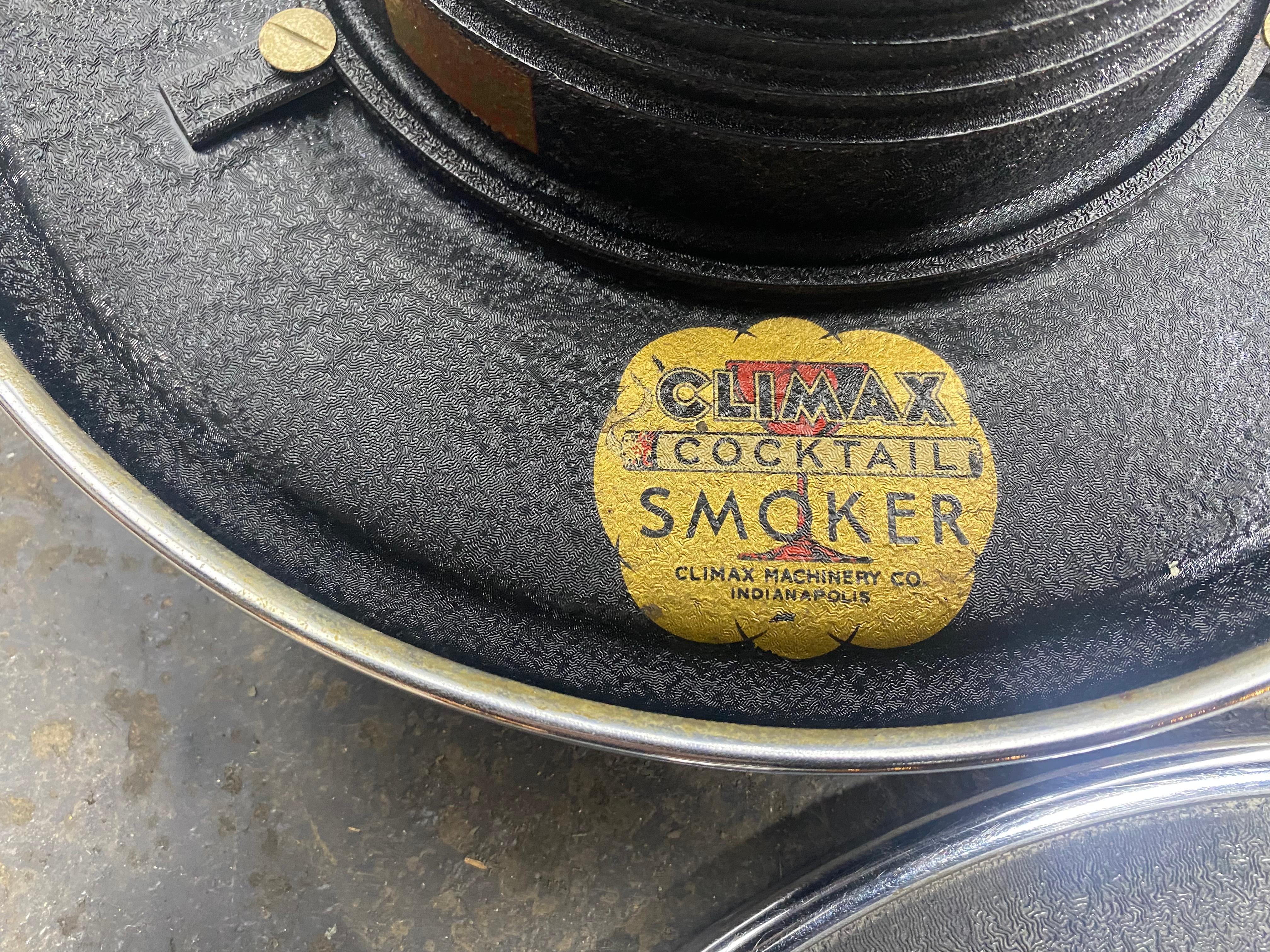 W.J. Campbell designed this art deco cocktail smoker in 1934 for the Climax Machinery Company of Indianapolis. The smoke stand and ashtray feature a circular ring which doubles as a tray and can be removed to serve drinks. The ashtray has a lifting
