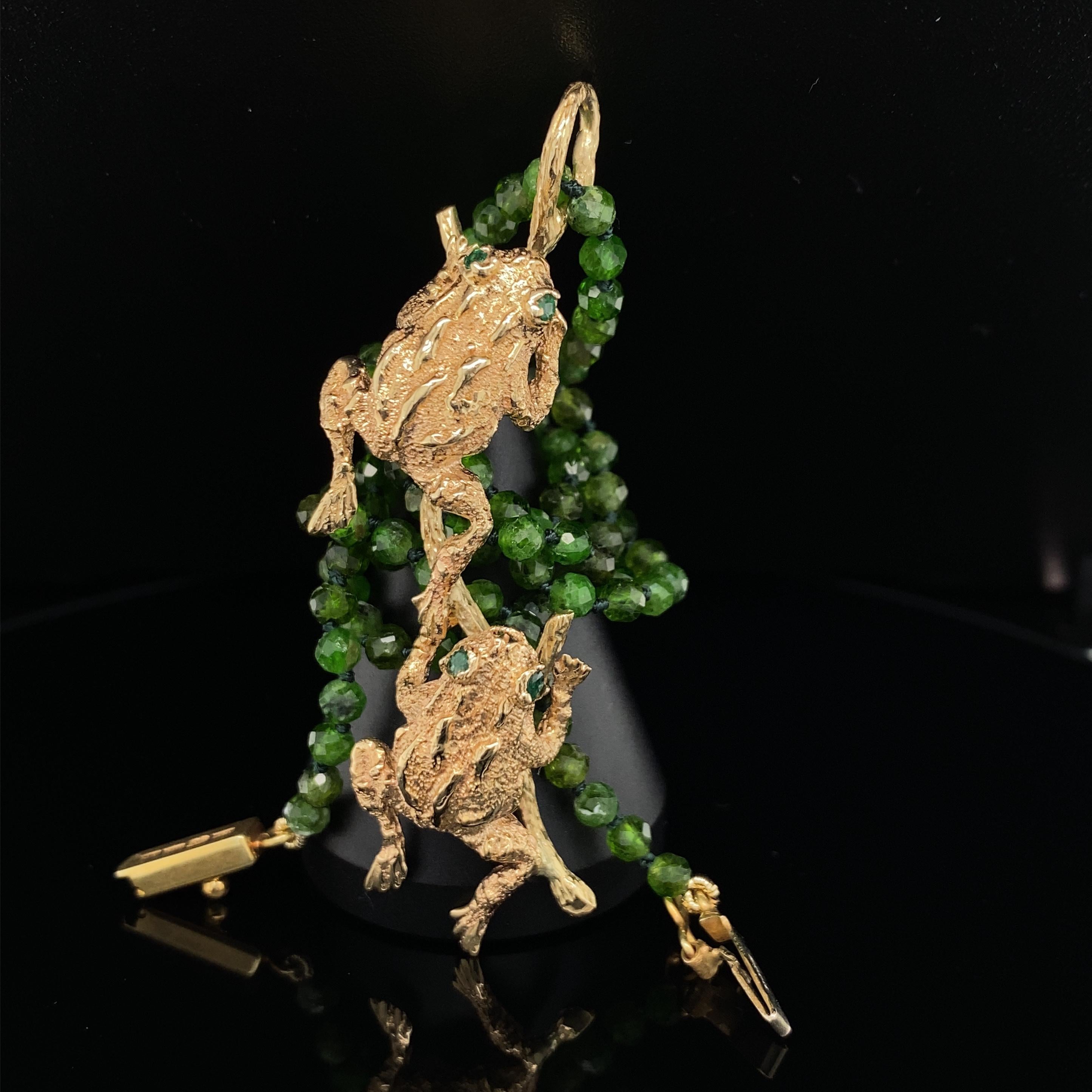 This determined pair of 14 karat gold frogs started out in life as pins.  We're not sure who made them (they have a maker's mark on their feet that we haven't been able to identify), but Eytan Brandes decided they'd be happier joined together as a