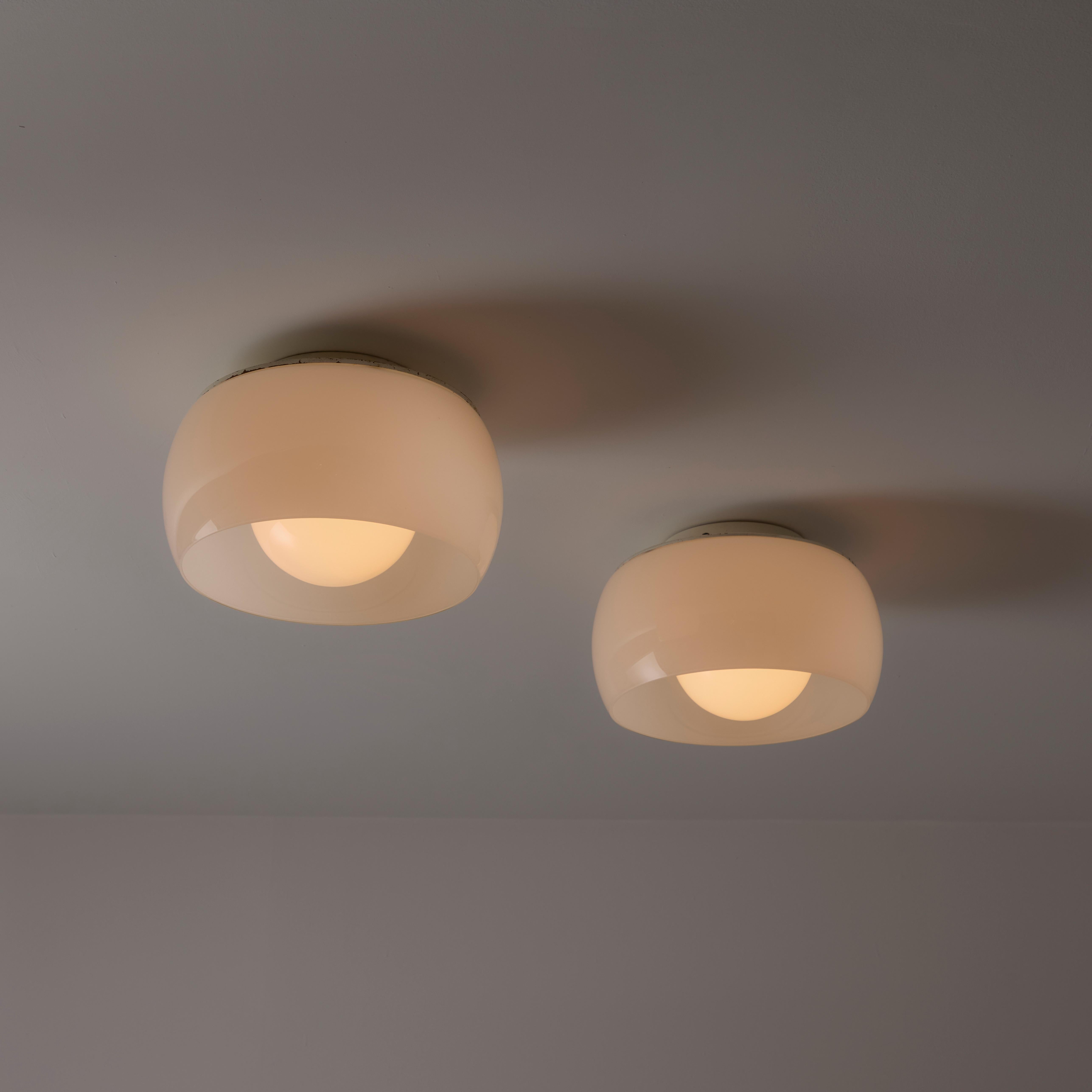 Single Clinio Flush Mount Ceiling Light by Vico Magistretti for Artemide. Designed and manufactured in Italy circa 1960 's. Opaline glass outer and inner diffuser. Enameled metal frame. Rewired for U.S. standards. Holds a single E27 socket type,