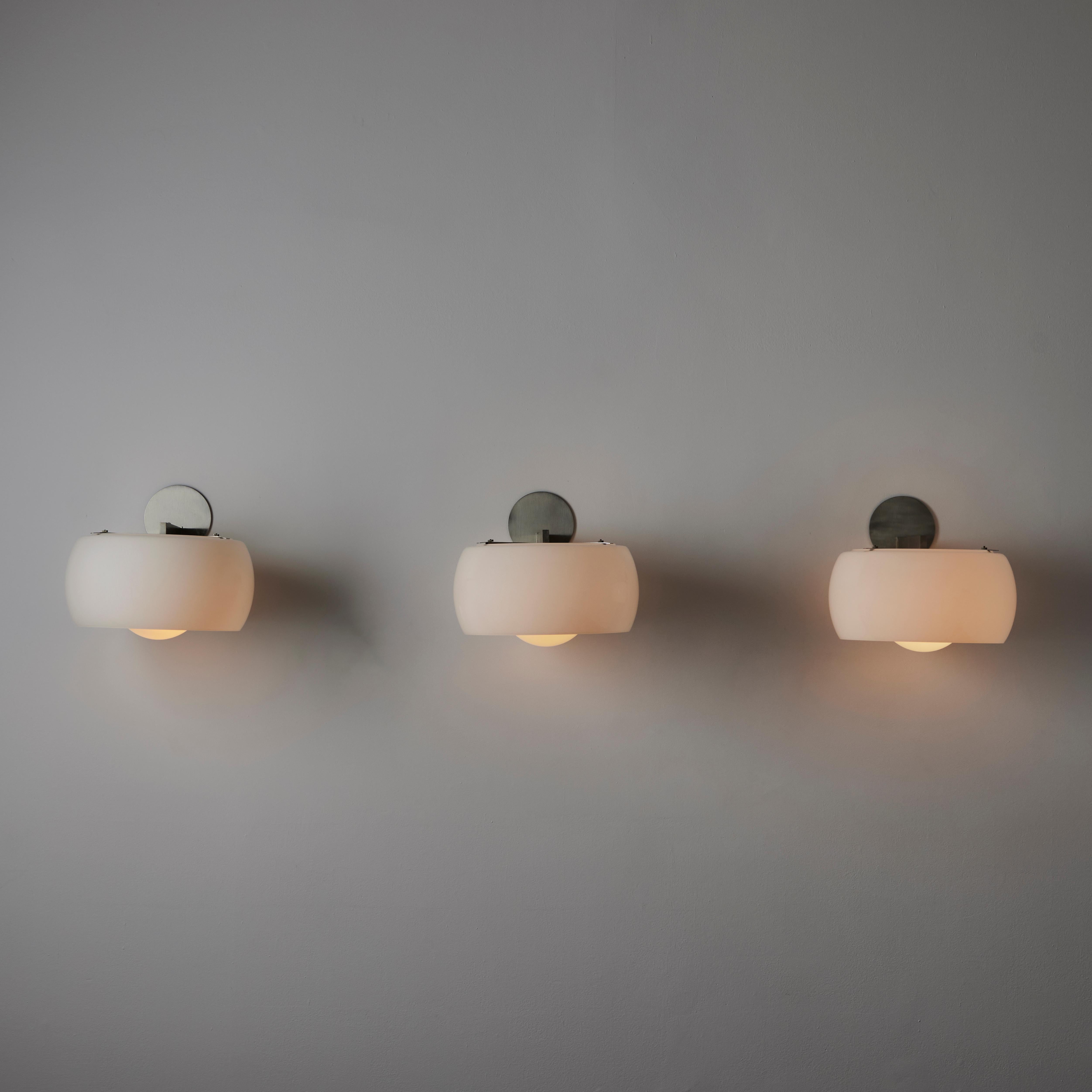 'Clinio' Wall Lights by Vico Magistretti for Artemide (IT, c.1961) Large opaline glass diffusers paired with brushed nickel armatures. Each light holds one E27 socket type, adapted for the US. We recommend a single 40w bulb. Rewired for the US.