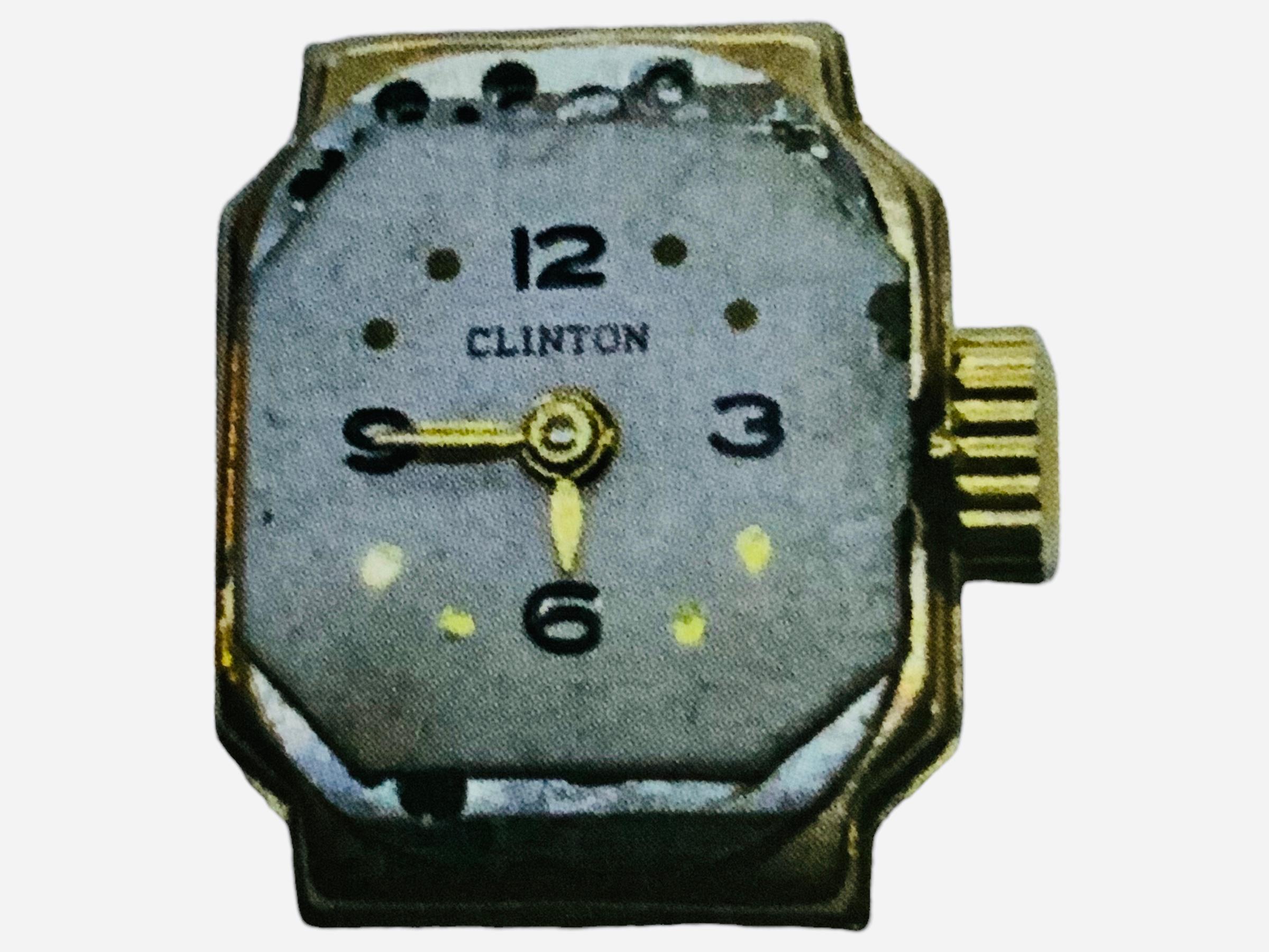 This is a Clinton - Champ Watch Co. Lady’s Wrist Watch. It depicts a 14K yellow gold square case with white color dial that has Arabic numerals/dots and gold color hour/minute hands. An acrylic material glass covers the case. The original gold