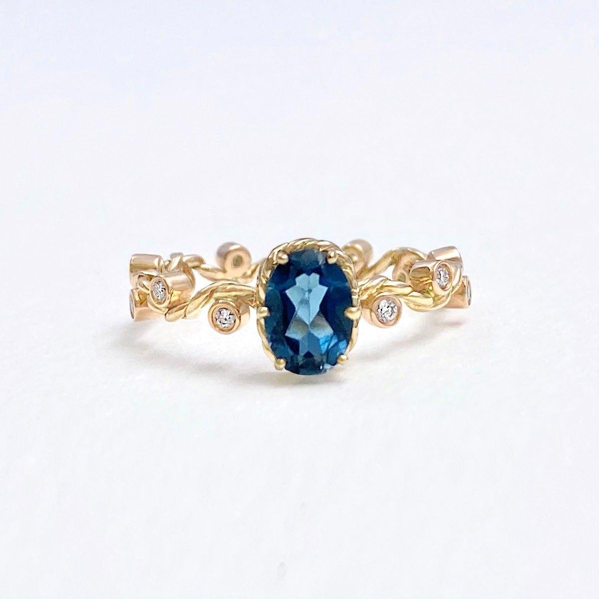 For Sale:  Clio London Blue Topaz Twist Vine Solitaire 18 Karat 5